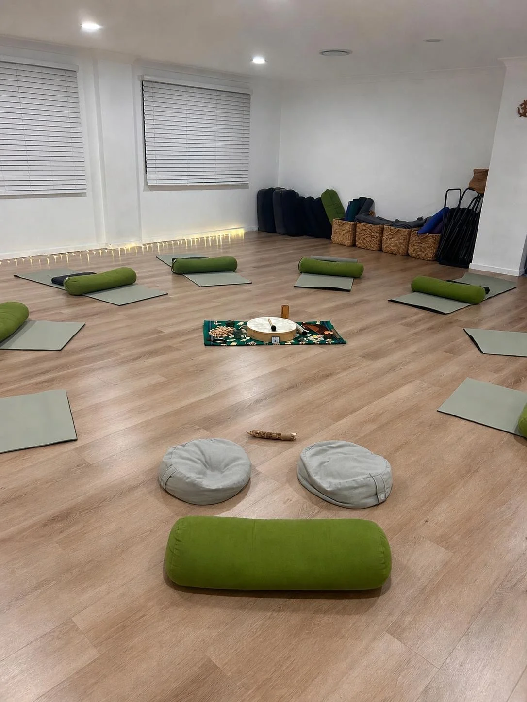 The Cronulla group breathwork circle space, with cushions, mats, and soft lighting set up for a session.