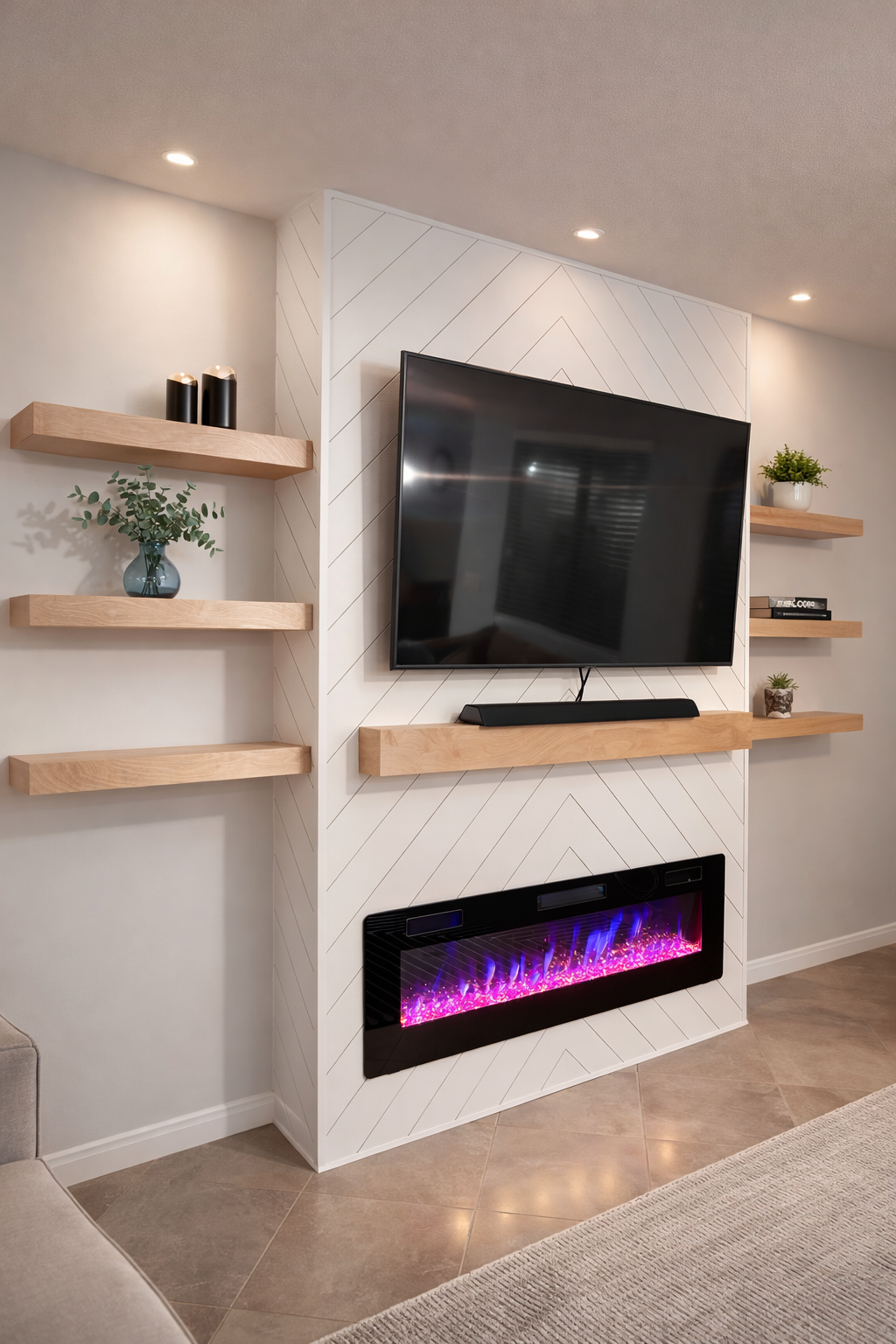 Living room TV wall with a large flat-screen TV, a soundbar, and a fireplace with purple and pink flames, framed by white wall tiles with diagonal lines. Two wooden shelves hold decorative items like vases, potted plants, and books.