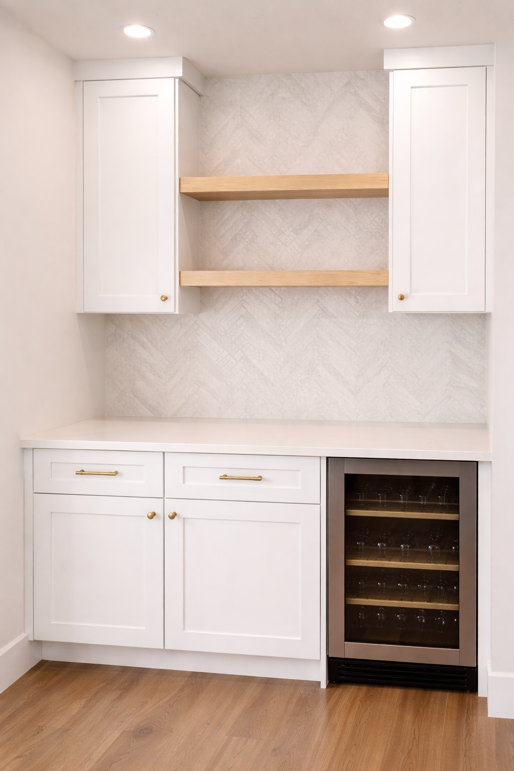 White kitchen cabinet with two doors, gold handles, a built-in wine cooler, and two wooden shelves in a kitchen with wooden floor.