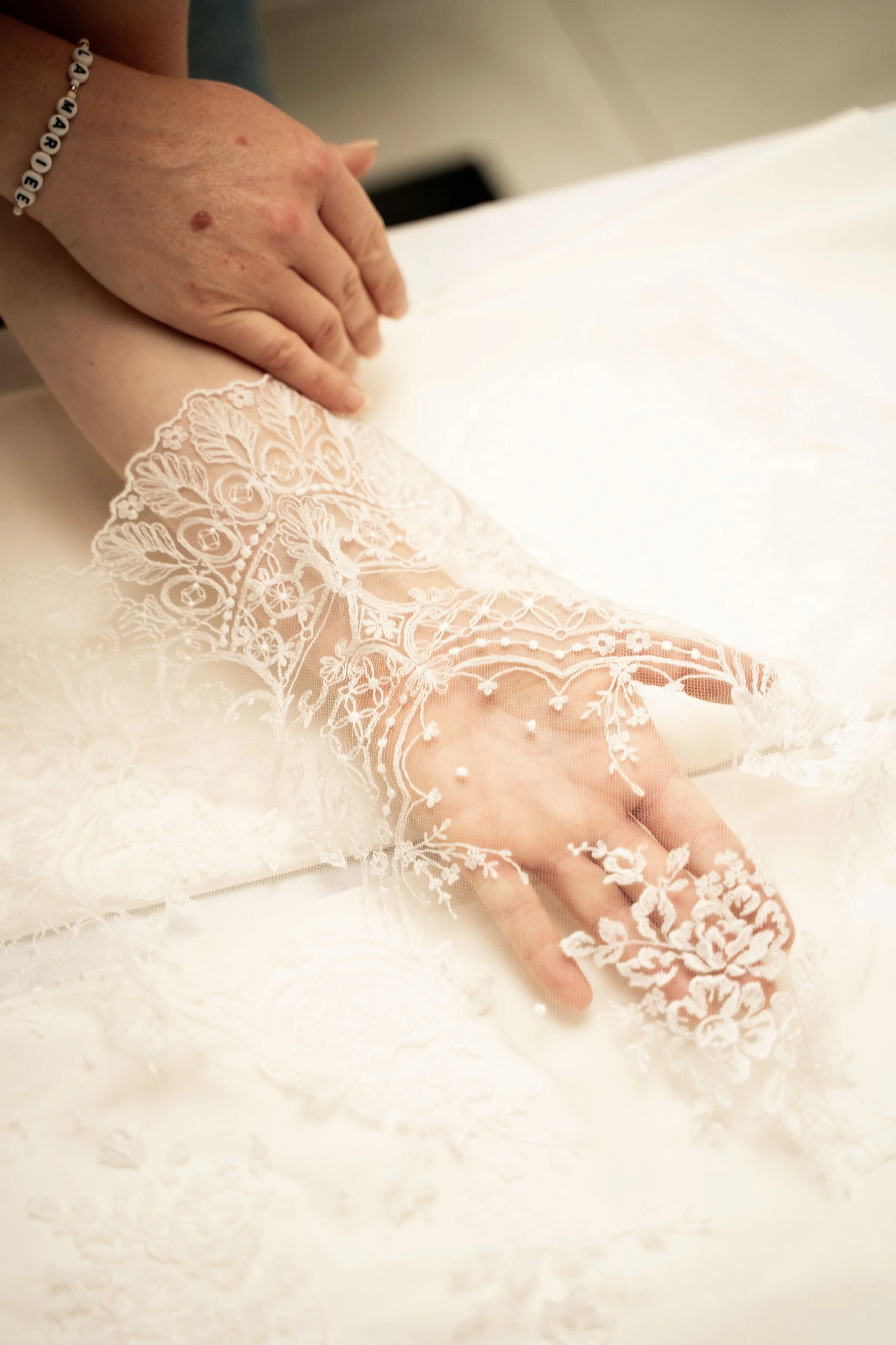 Détail de dentelle et finitions artisanales sur robe de mariée — studio nepita