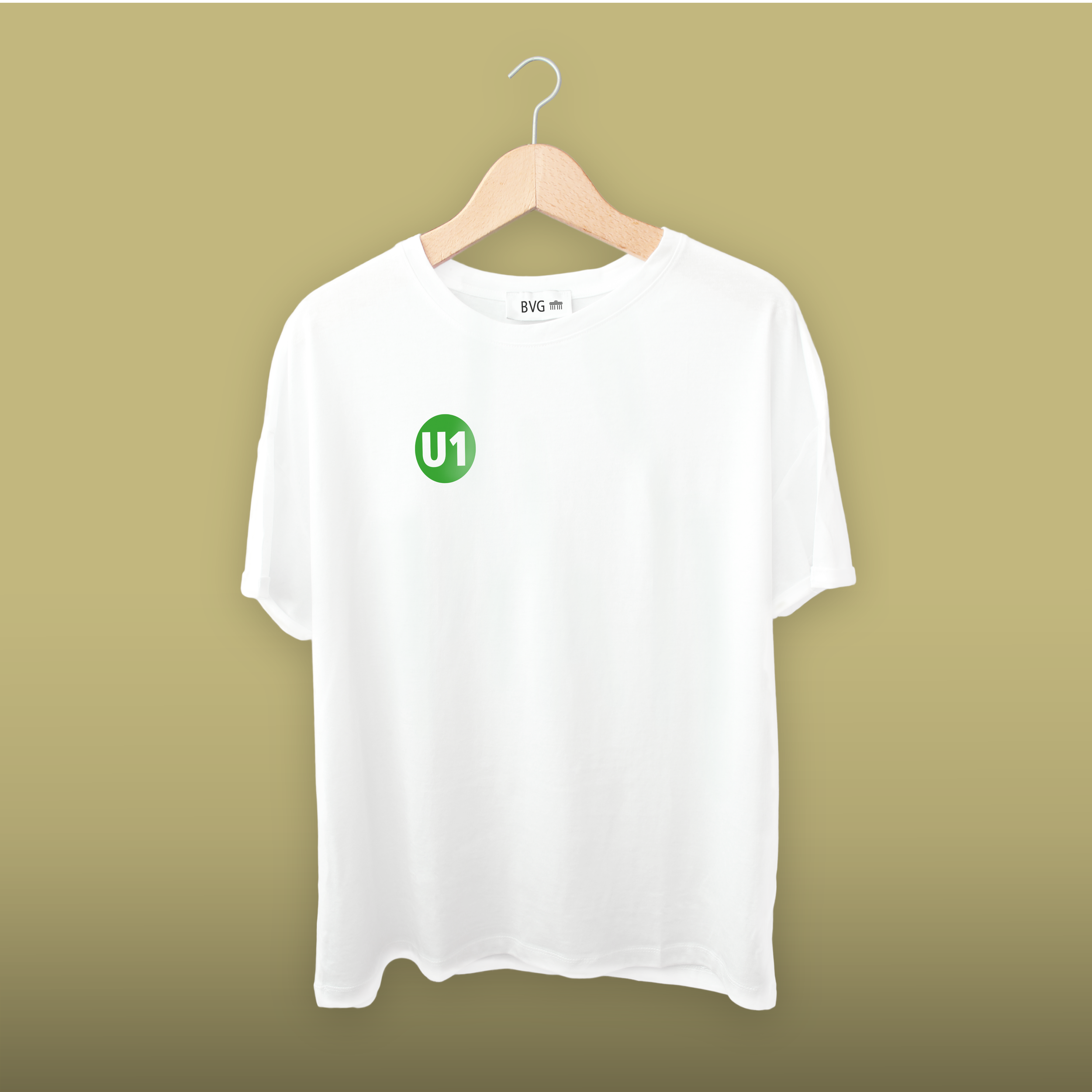 Weißes T-Shirt auf Kleiderbügel vor grünlichem Hintergrund, mit grünem U1-Logo auf der Brustseite.