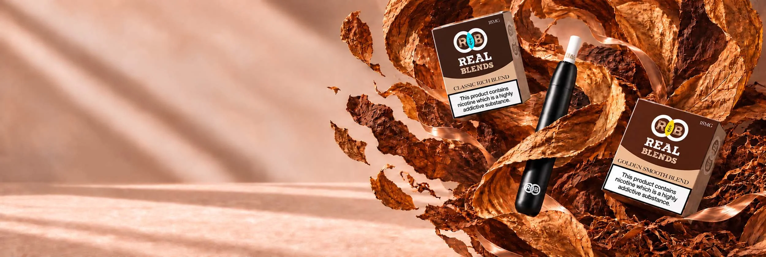 Vape pens and their packaging boxes surrounded by brown, crumpled metallic-looking decorative leaves for a promotional display.