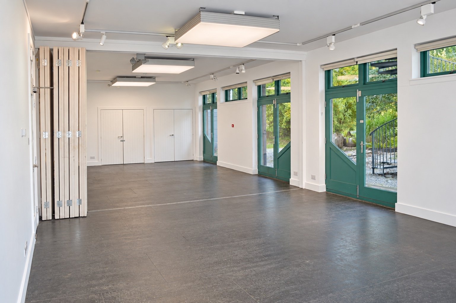Class Rooms A and B with open partition and several doors leading to the garden.