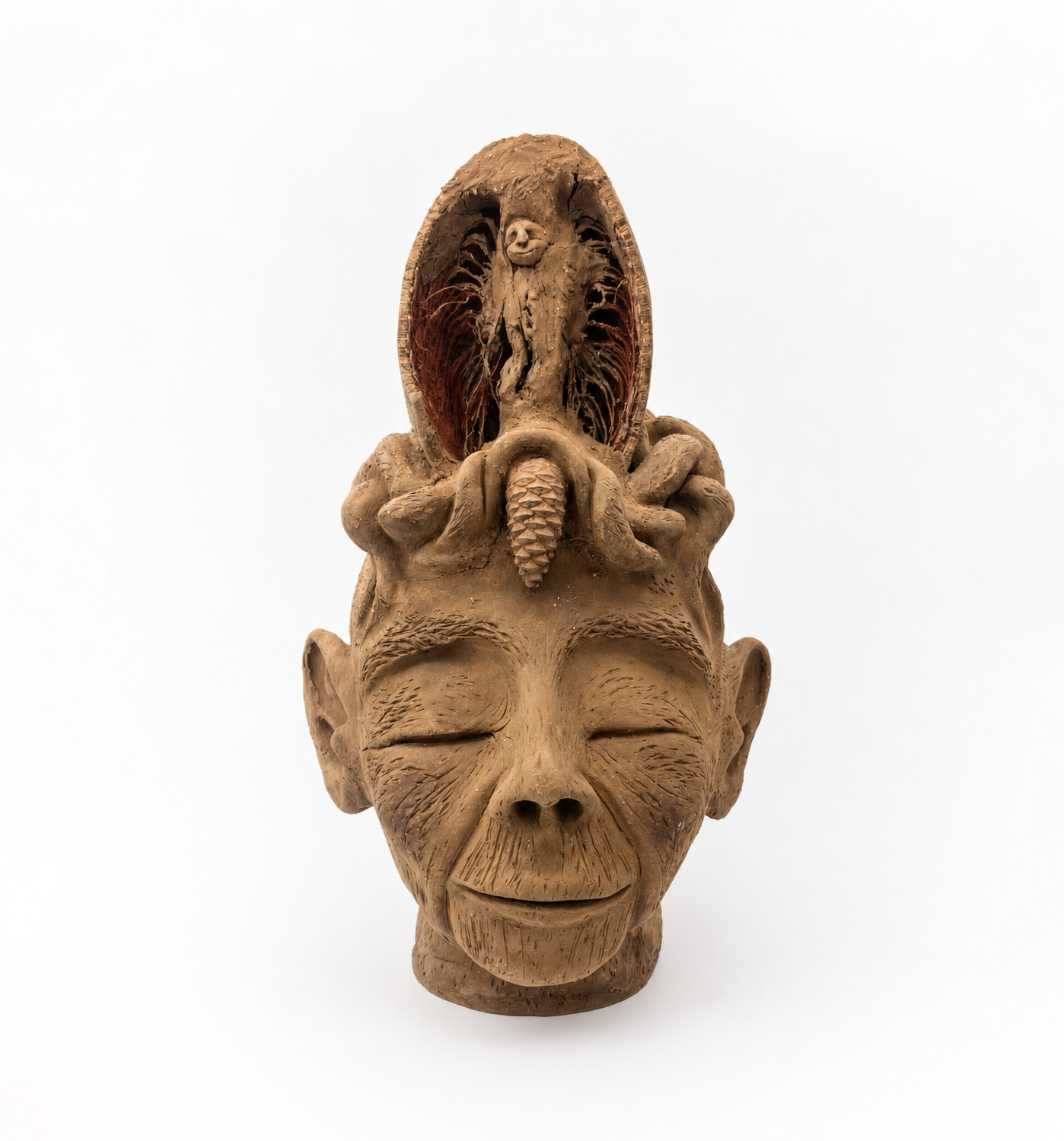 The Shaman, a handmade natural earth sculpture by Roni Hirsch depicting a spiritual guide with a closed pine cone on his forehead and a guiding figure emerging above him