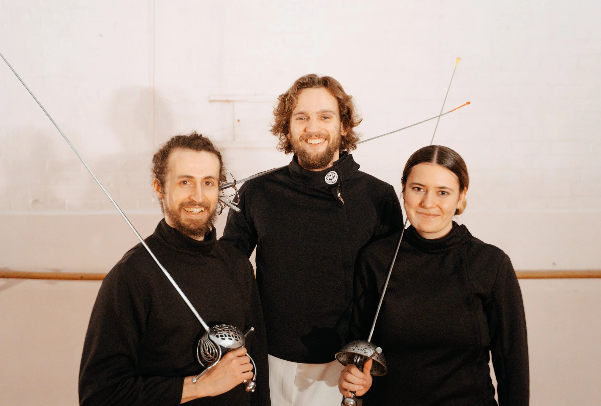 The team of Melbourne Historical Fencing are happily posing together for a group photo.