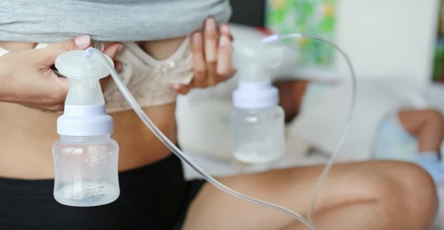 Close-up of a person with a nebulizer, administering medication to a small child in the background.