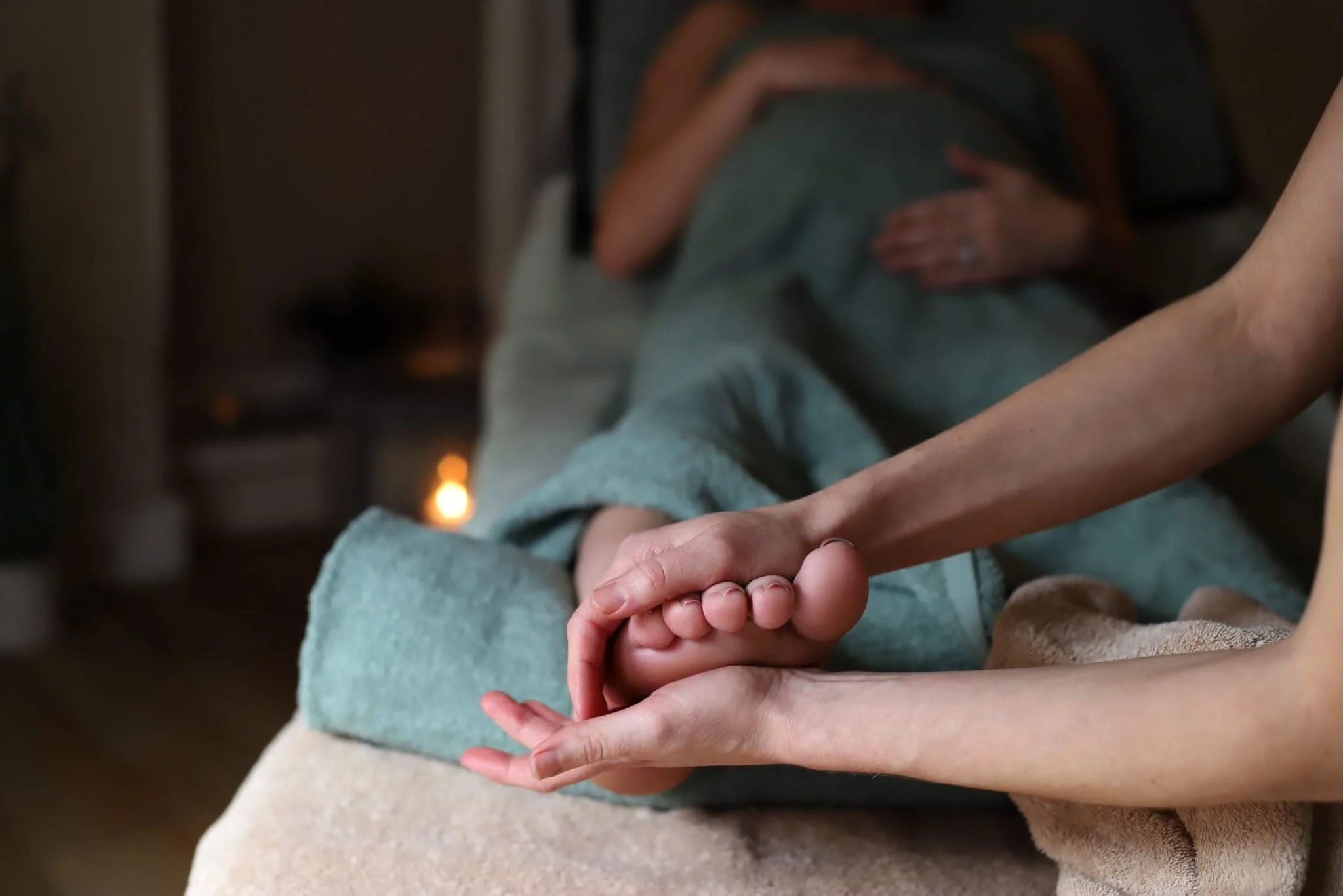 A pregnant lady having a foot massage and reflexology.