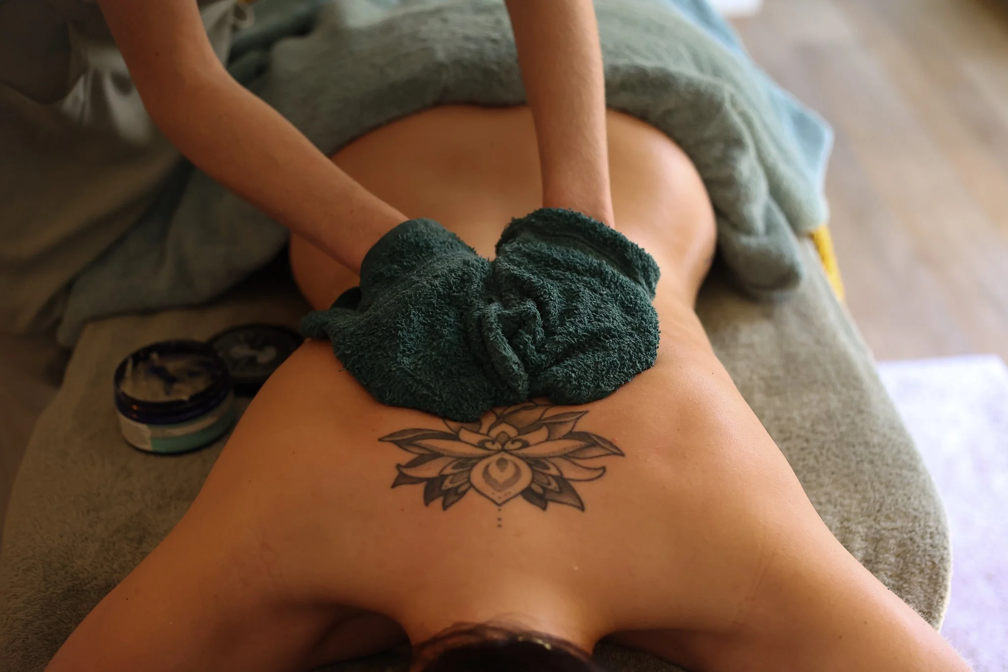 A person having a Neal's Yard Remedies Organic salt back scrub, cleanse and massage.