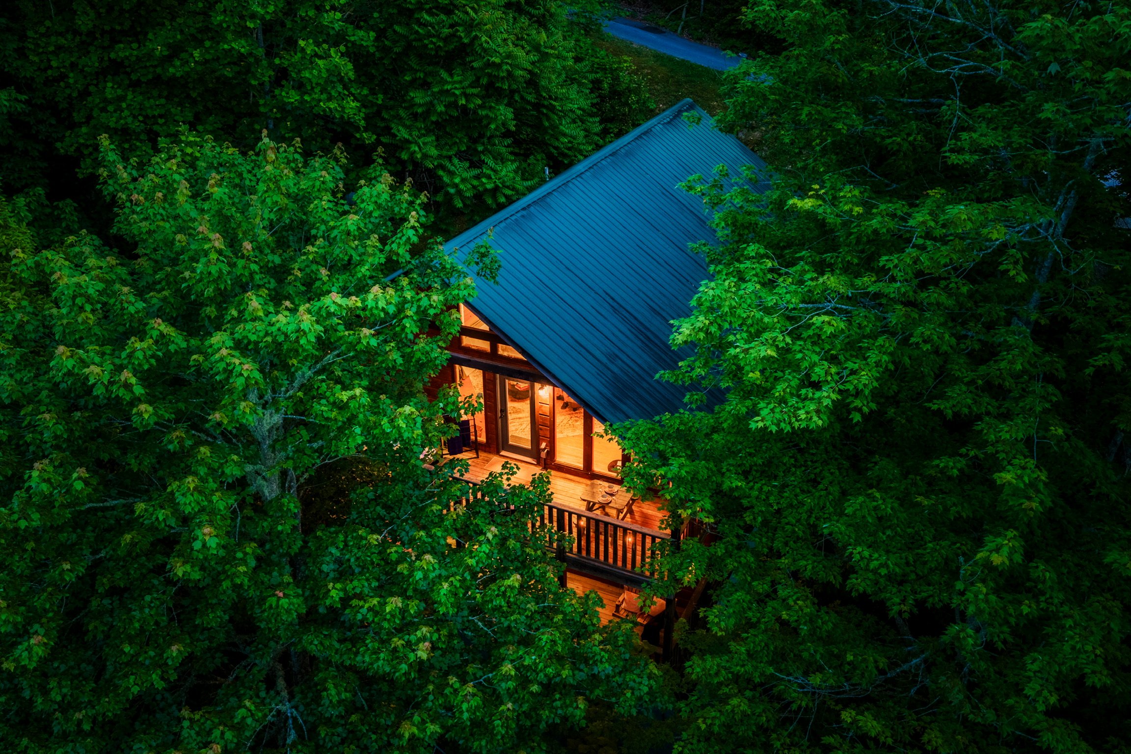 Aerial view of Blue Sage Hideaway cabin with teal roof