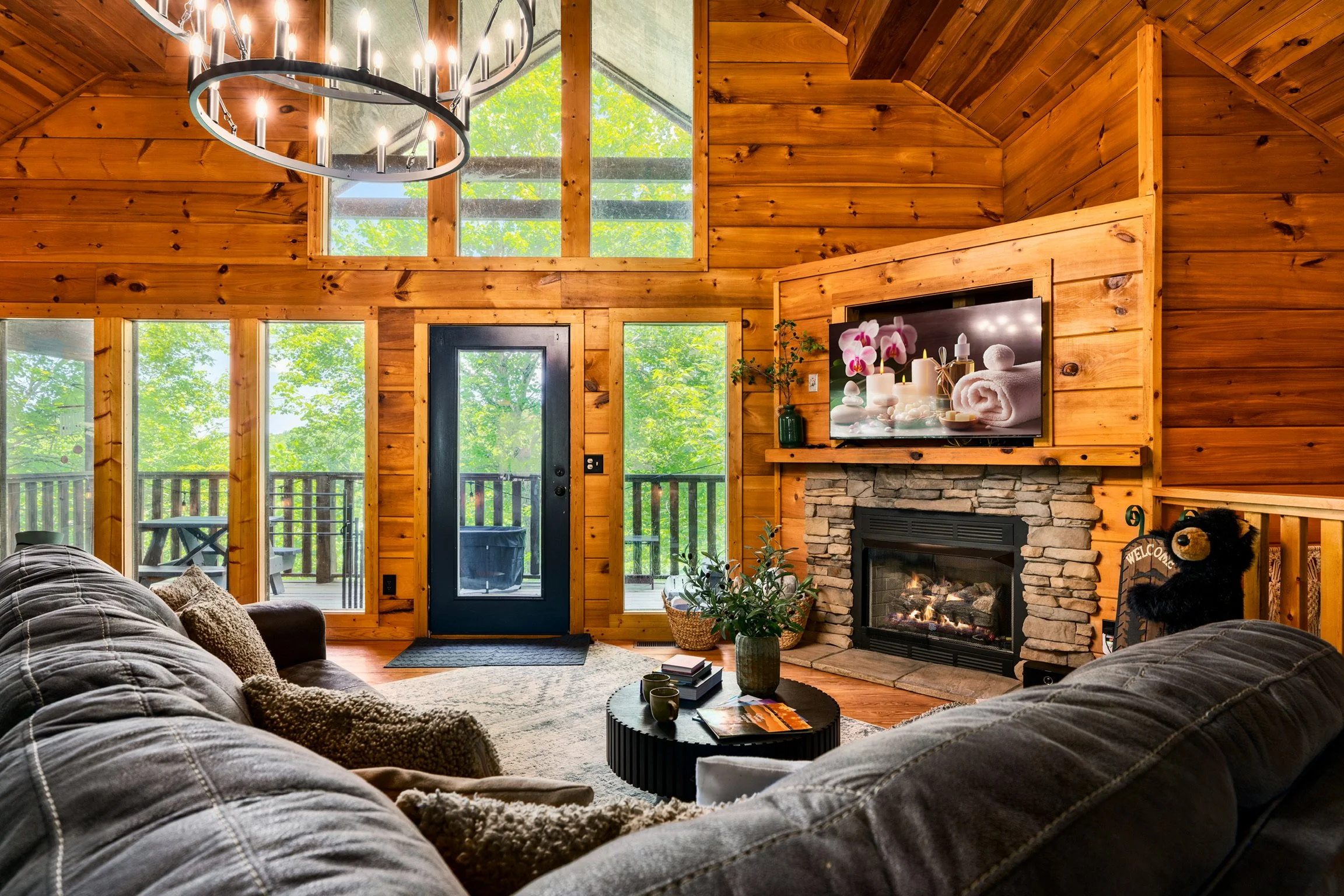 Blue Sage Hideaway living room with stone fireplace and leather sectional