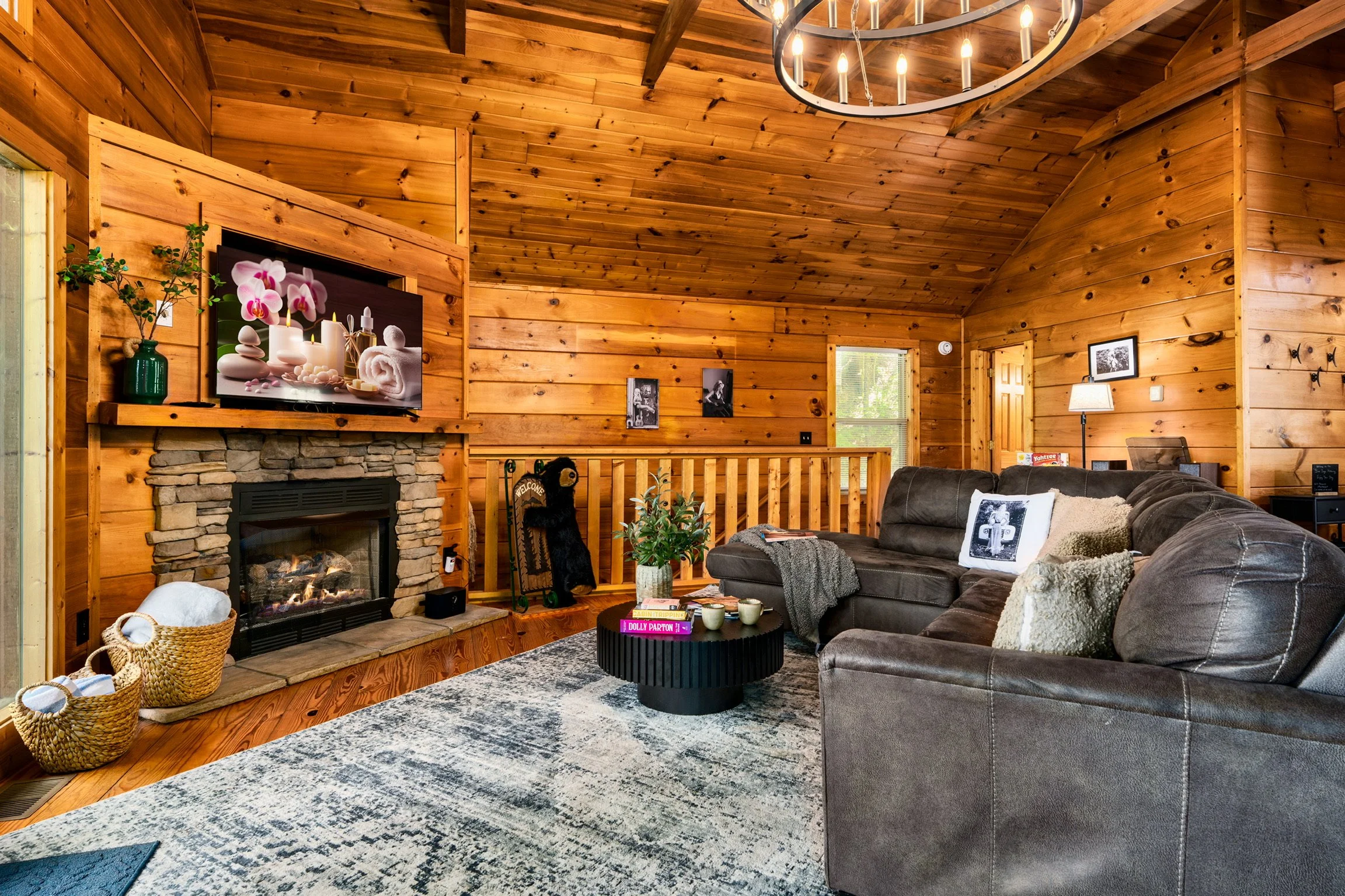 Blue Sage Hideaway living room with stone fireplace, leather sectional, and TV