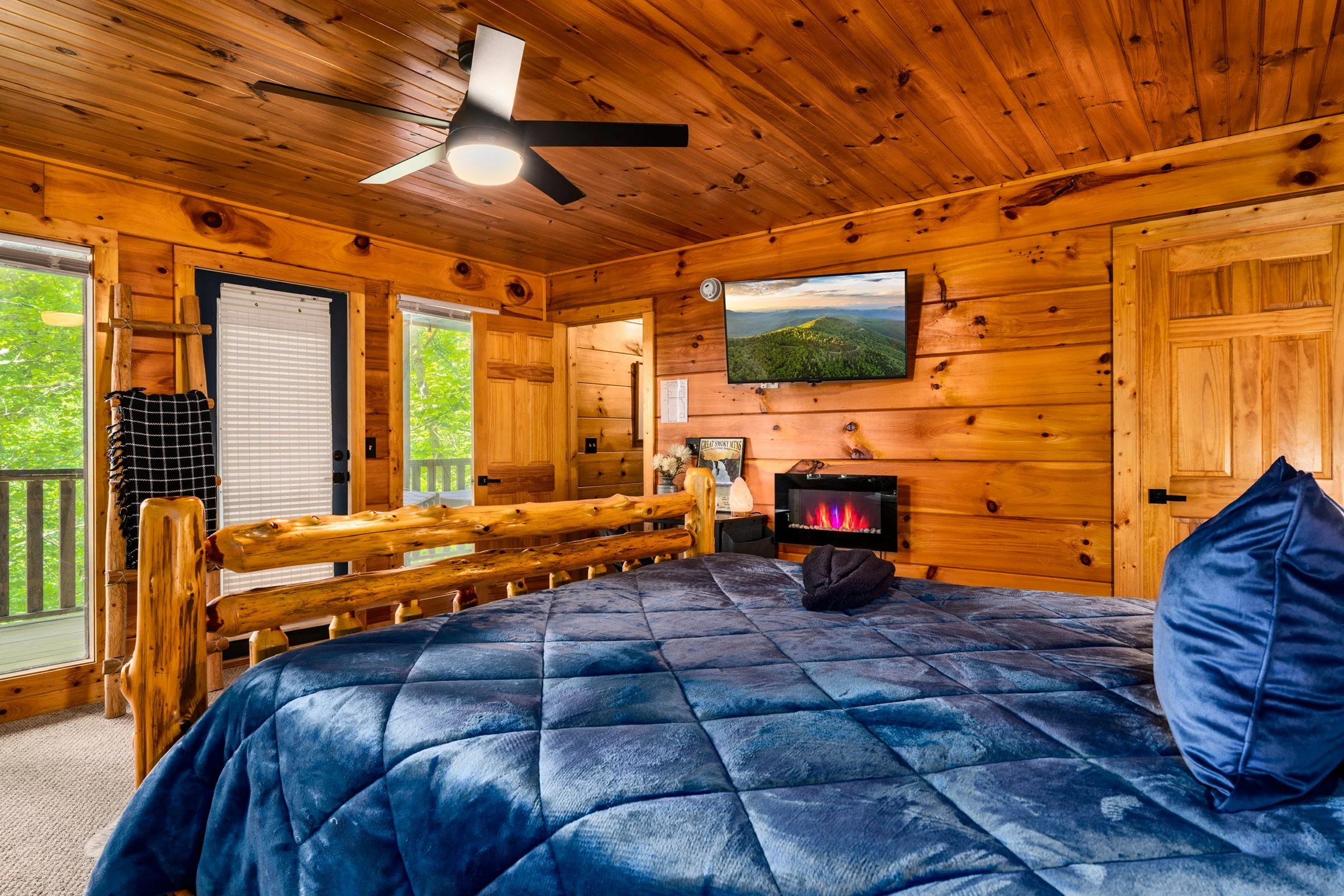 3. Blue Sage Hideaway bedroom with blue comforter and electric fireplace
