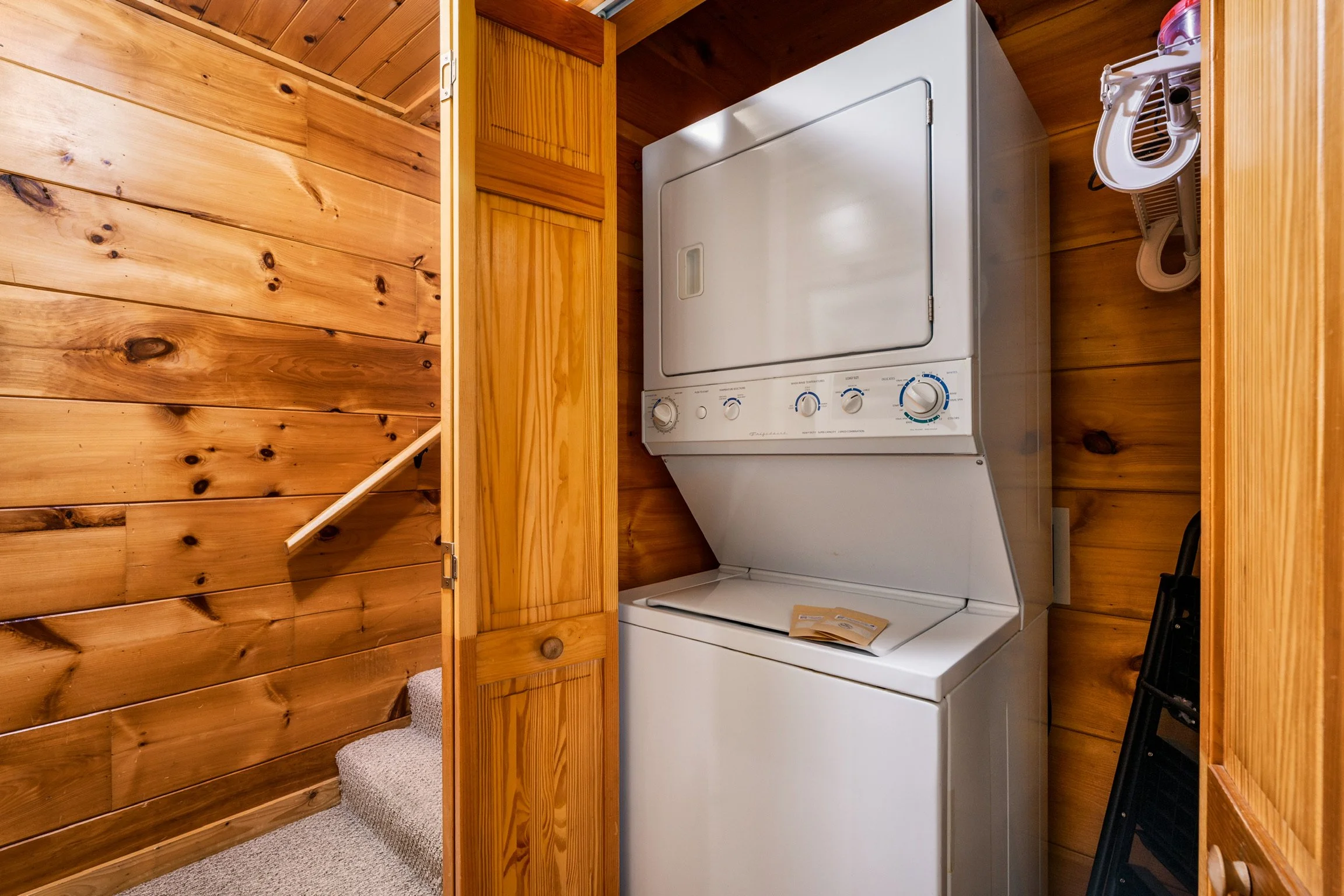 Blue Sage Hideaway stairwell and laundry closet with stacked washer and dryer
