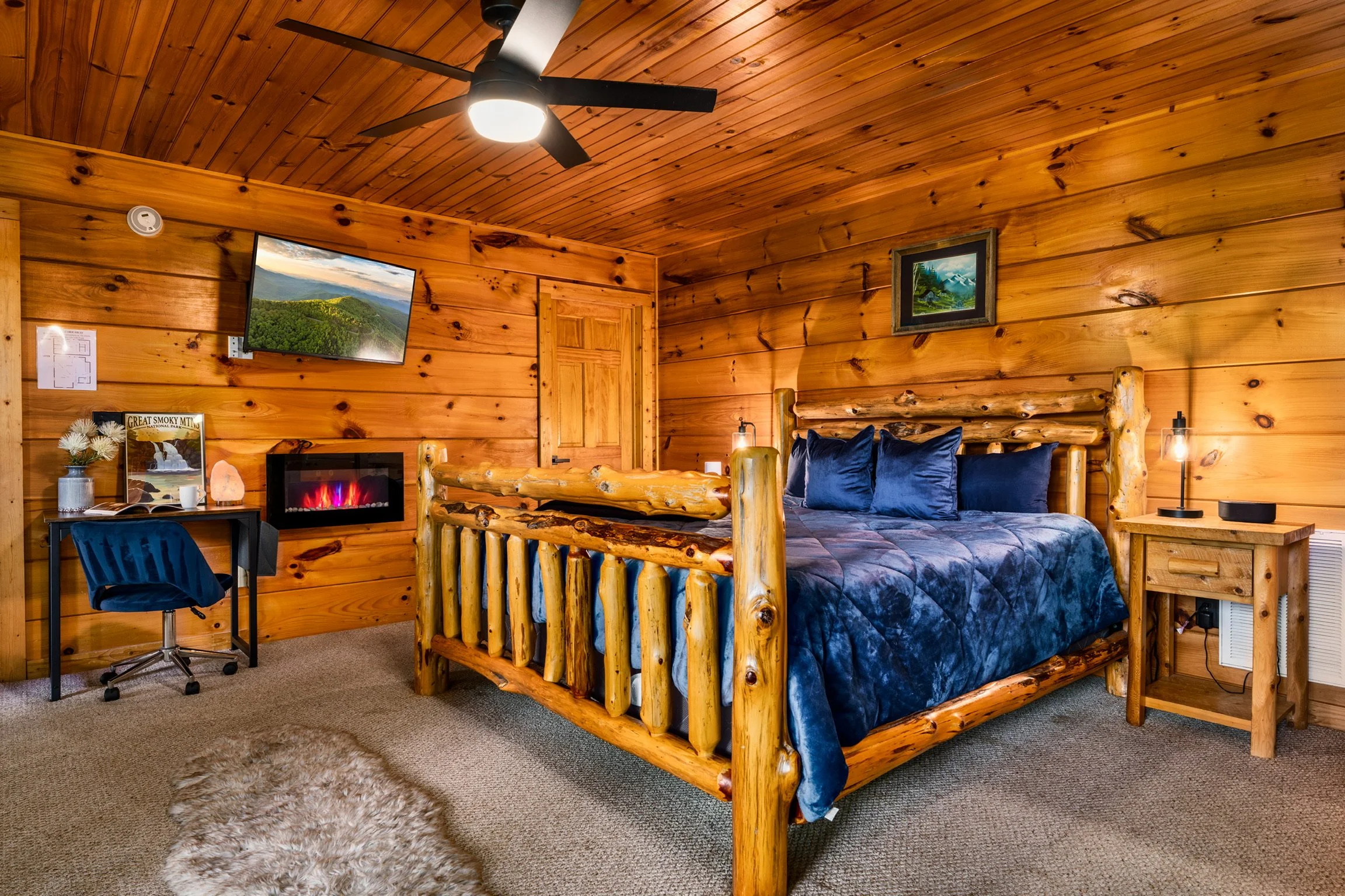 Blue Sage Hideaway bedroom with log-frame bed and blue bedding