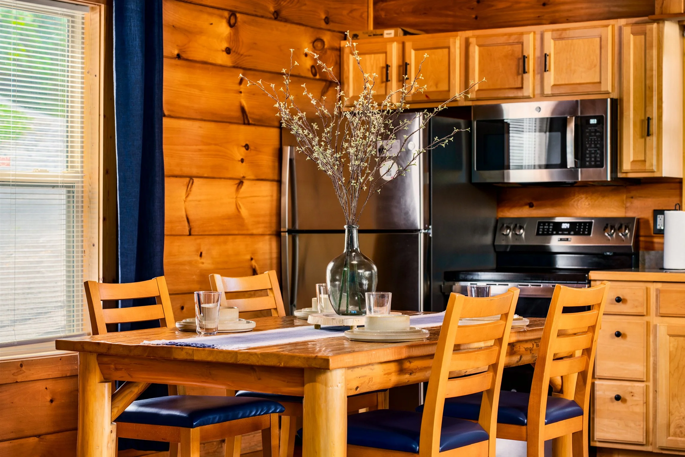 Blue Sage Hideaway dining table with stainless refrigerator 