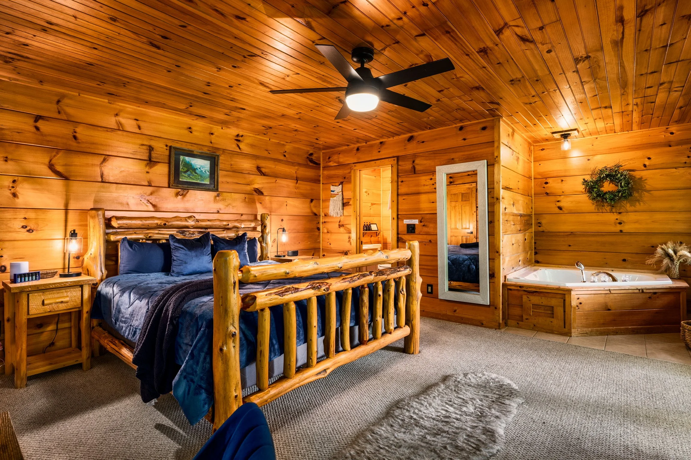 Blue Sage Hideaway bedroom with log-frame bed and mirror