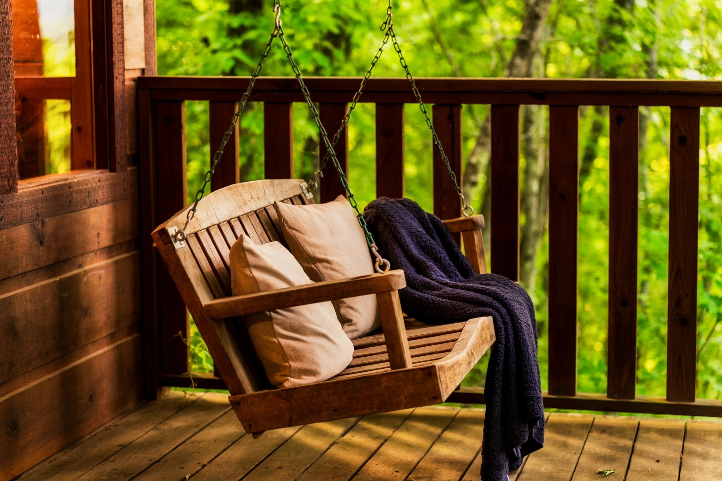 Blue Sage Hideaway lower level balcony covered porch with hanging swing