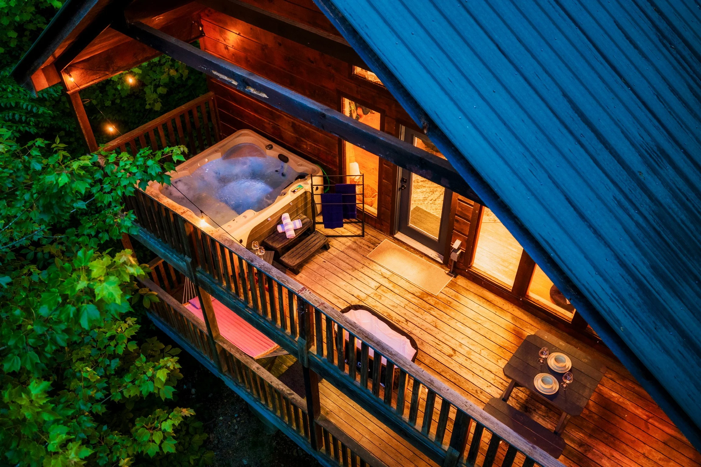 Aerial view of Blue Sage Hideaway deck with hot tub at dusk
