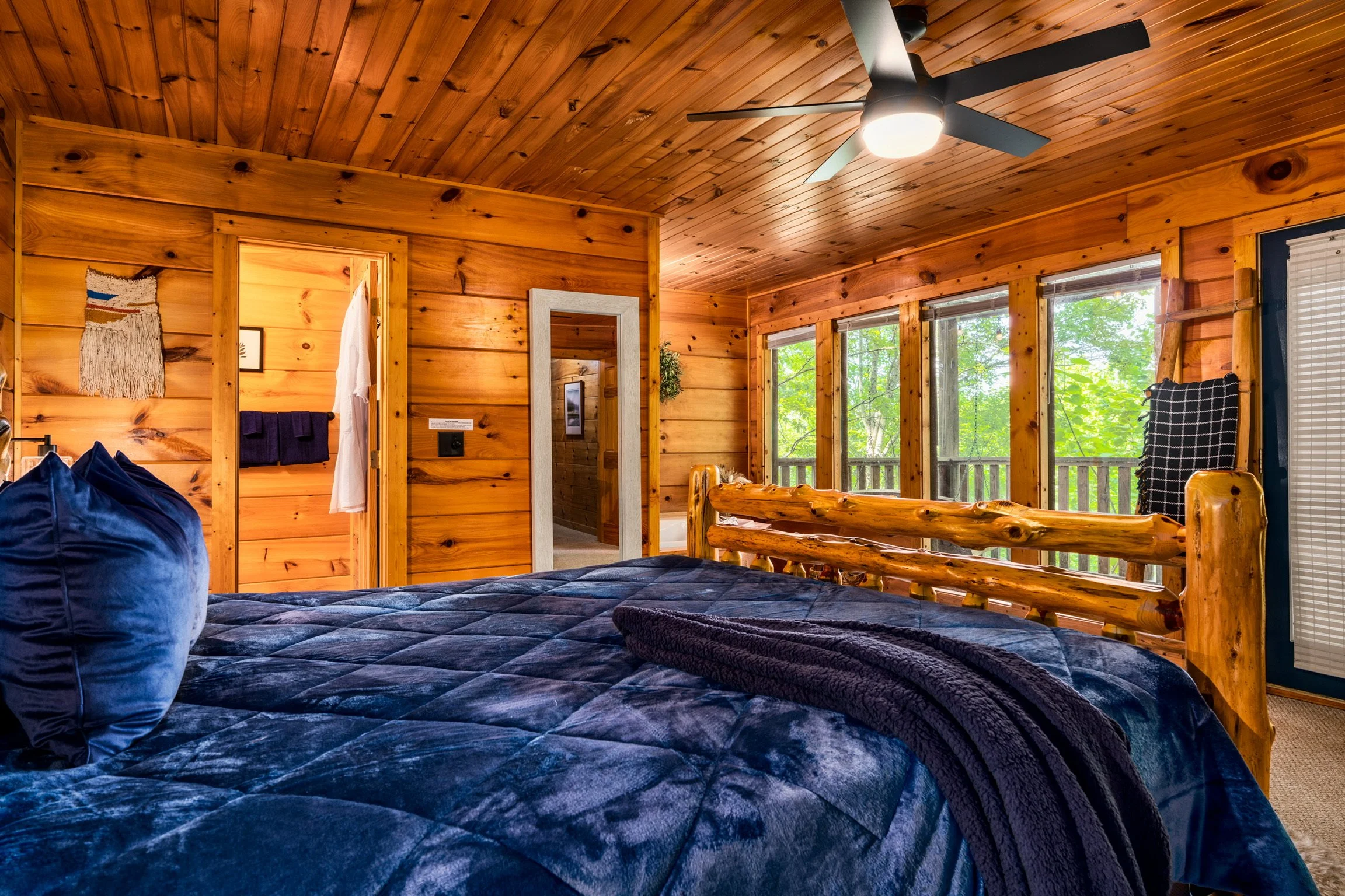 Blue Sage Hideaway bedroom with blue bedding, window view