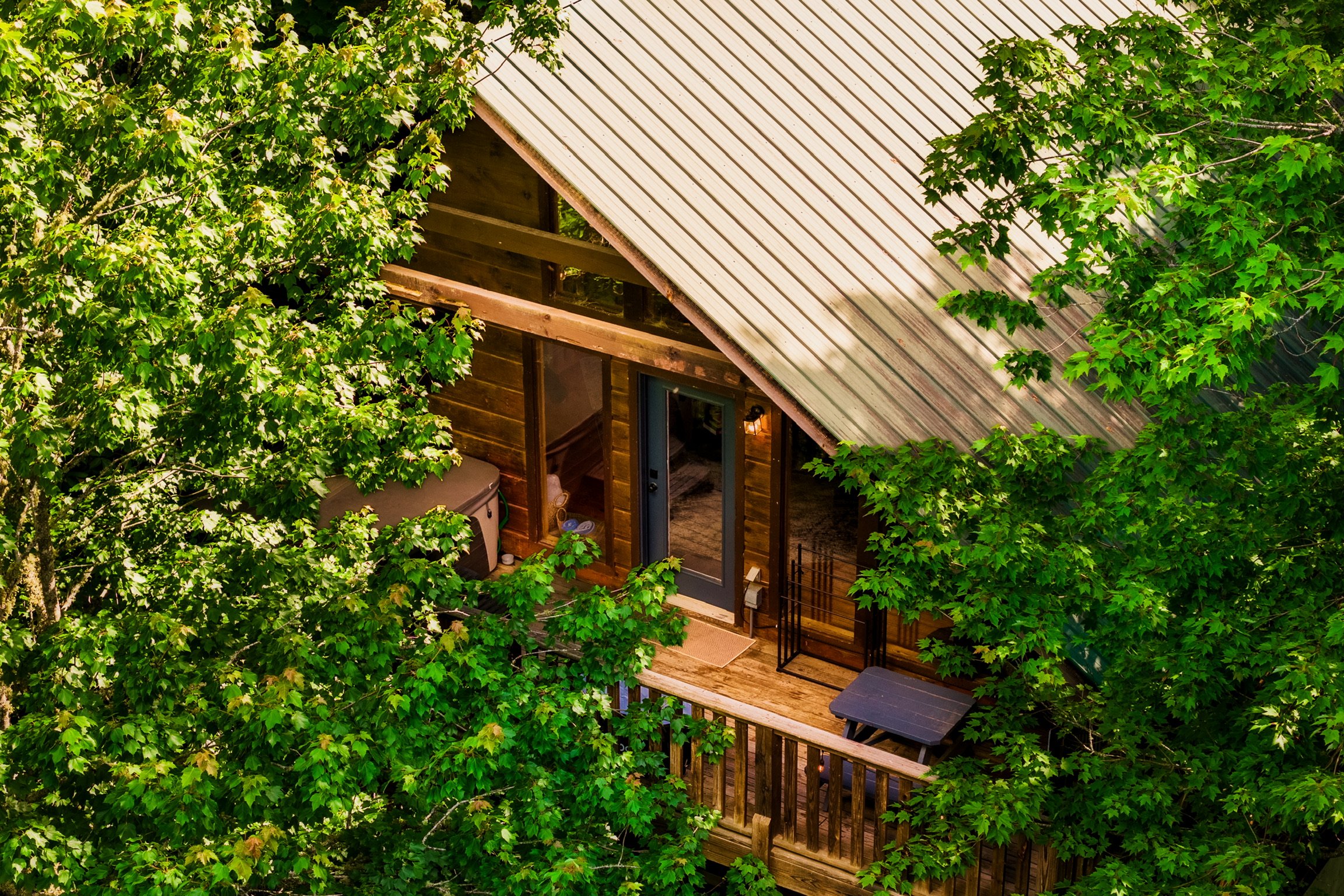 Aerial view of Blue Sage Hideaway cabin exterior with deck