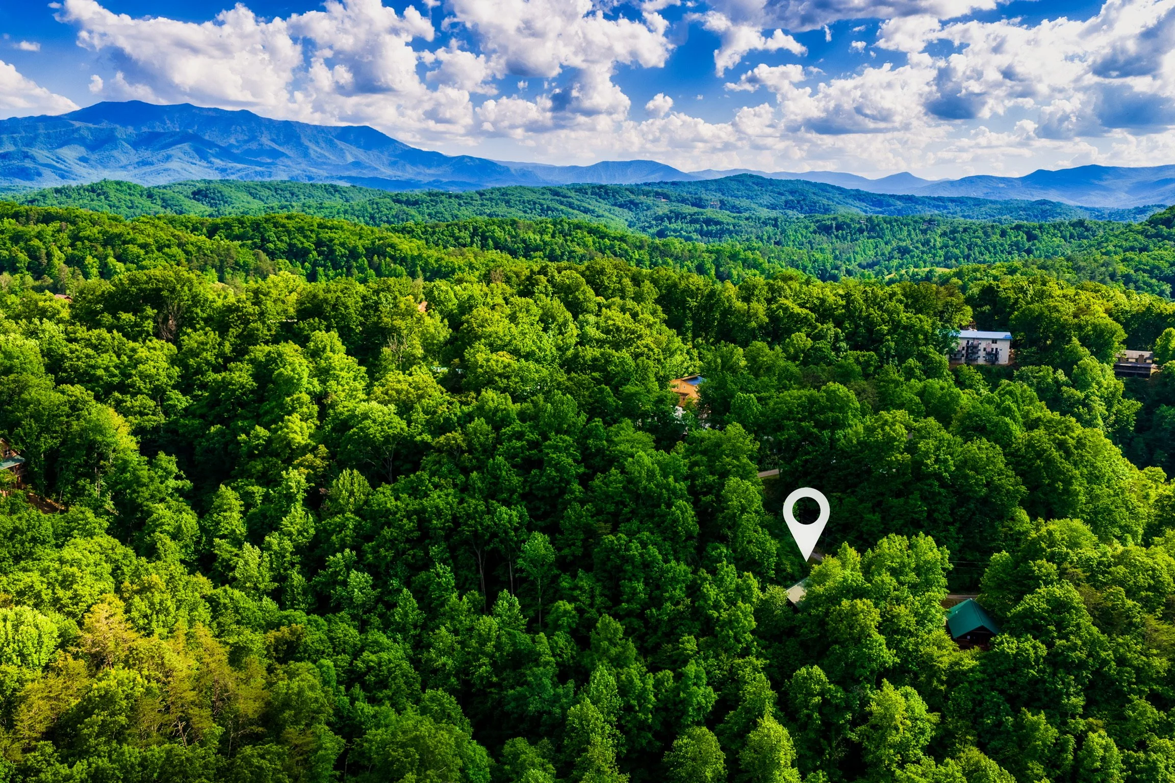 Aerial view of Blue Sage Hideaway property location pin among trees
