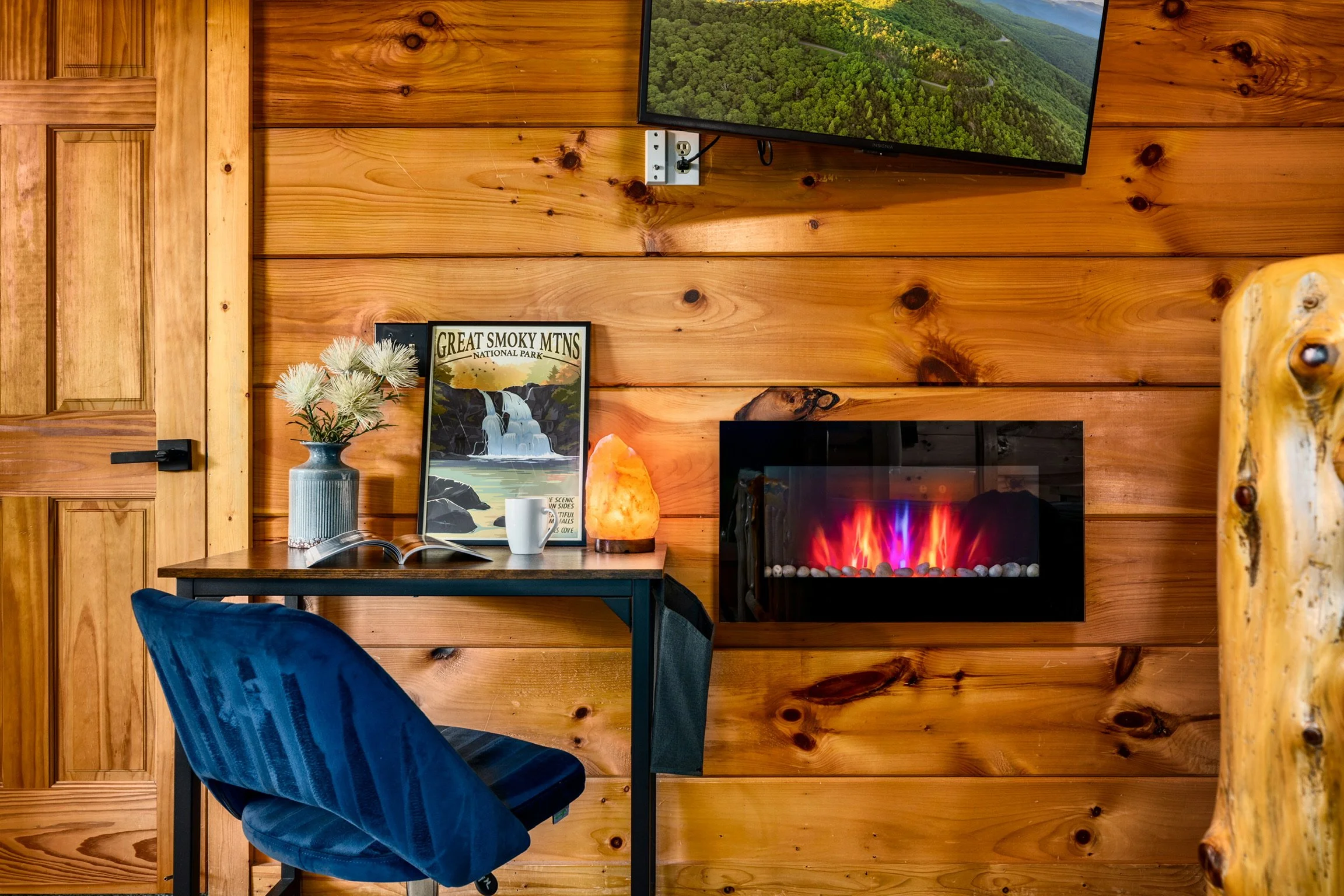 Blue Sage Hideaway bedroom desk with electric fireplace and TV