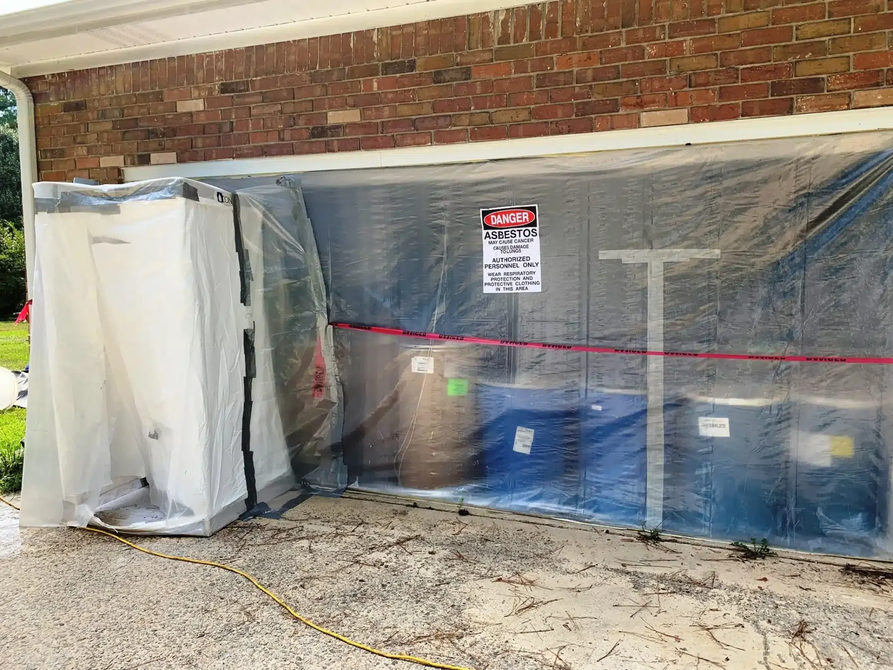 CIDS asbestos abatement containment area with asbestos warning signs