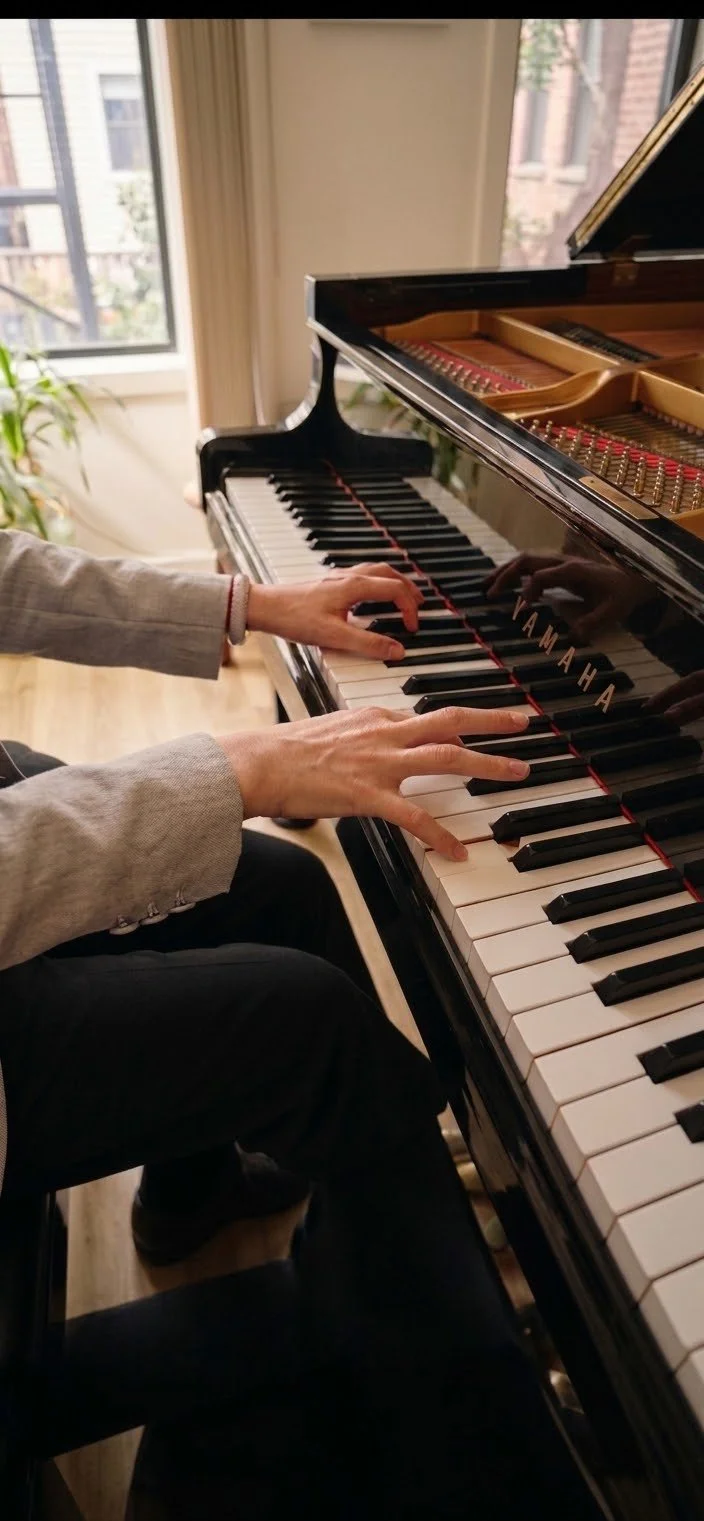 Fingers playing piano in a studio