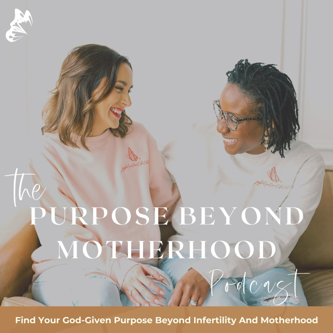 Two women sitting together on a couch, smiling and looking at each other. One has shoulder-length brown hair and is wearing a pink sweatshirt, while the other has short dreadlocks, glasses, and is wearing a white sweatshirt. The text on the image reads, 'The Purpose Beyond Motherhood Podcast,' with a subtitle, 'Find Your God-Given Purpose Beyond Infertility And Motherhood.'