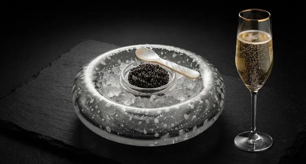 Reserve Haute champagne specialist and caviar sommelier pouring premium pairings for an exclusive gathering.