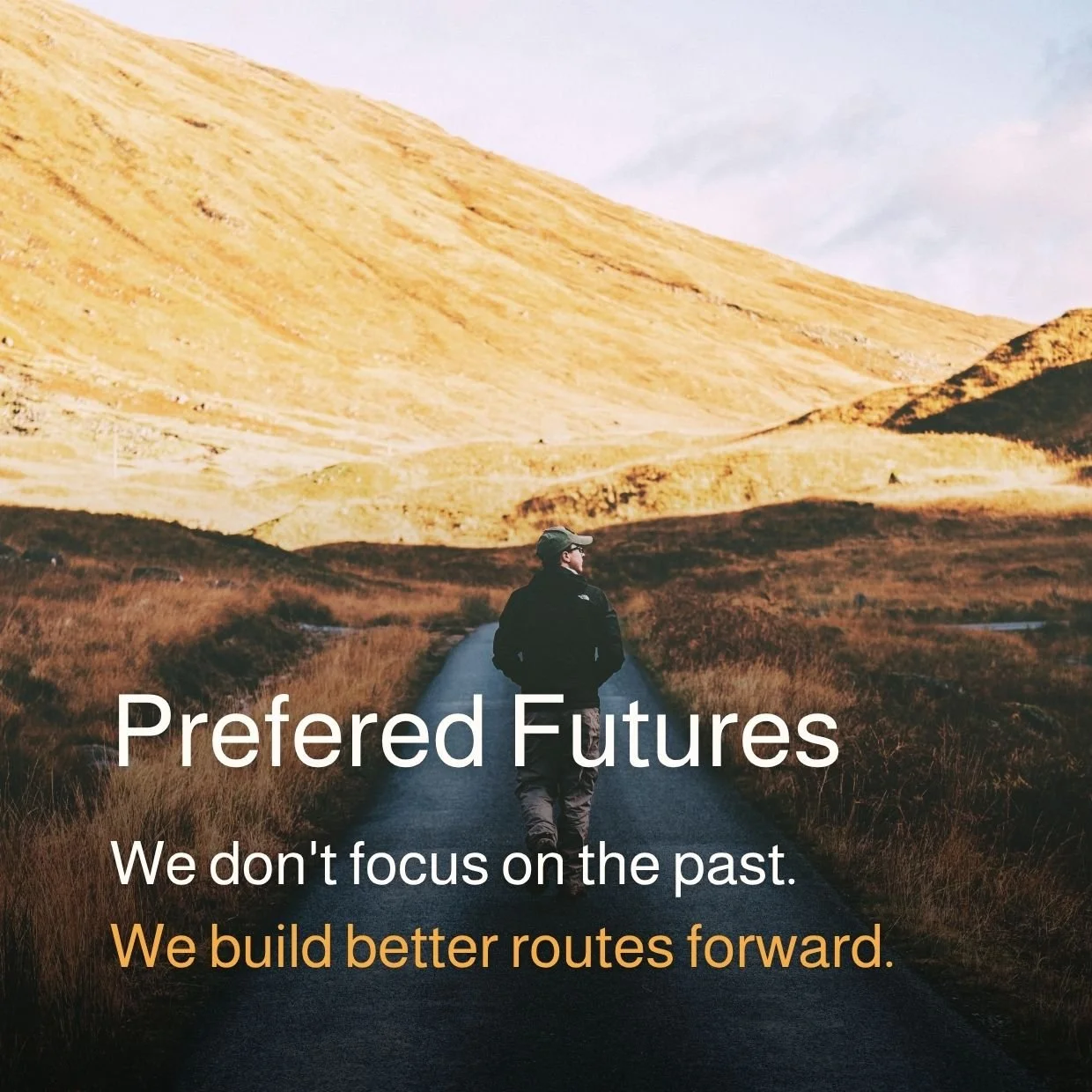A person walking along a paved road through a hilly landscape with golden grass, with a caption that says "Preferred Futures. We don't focus on the past. We build better routes forward."