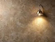 A Polished Venetian Plaster wall with a single downward-facing light fixture casting a warm yellow light.