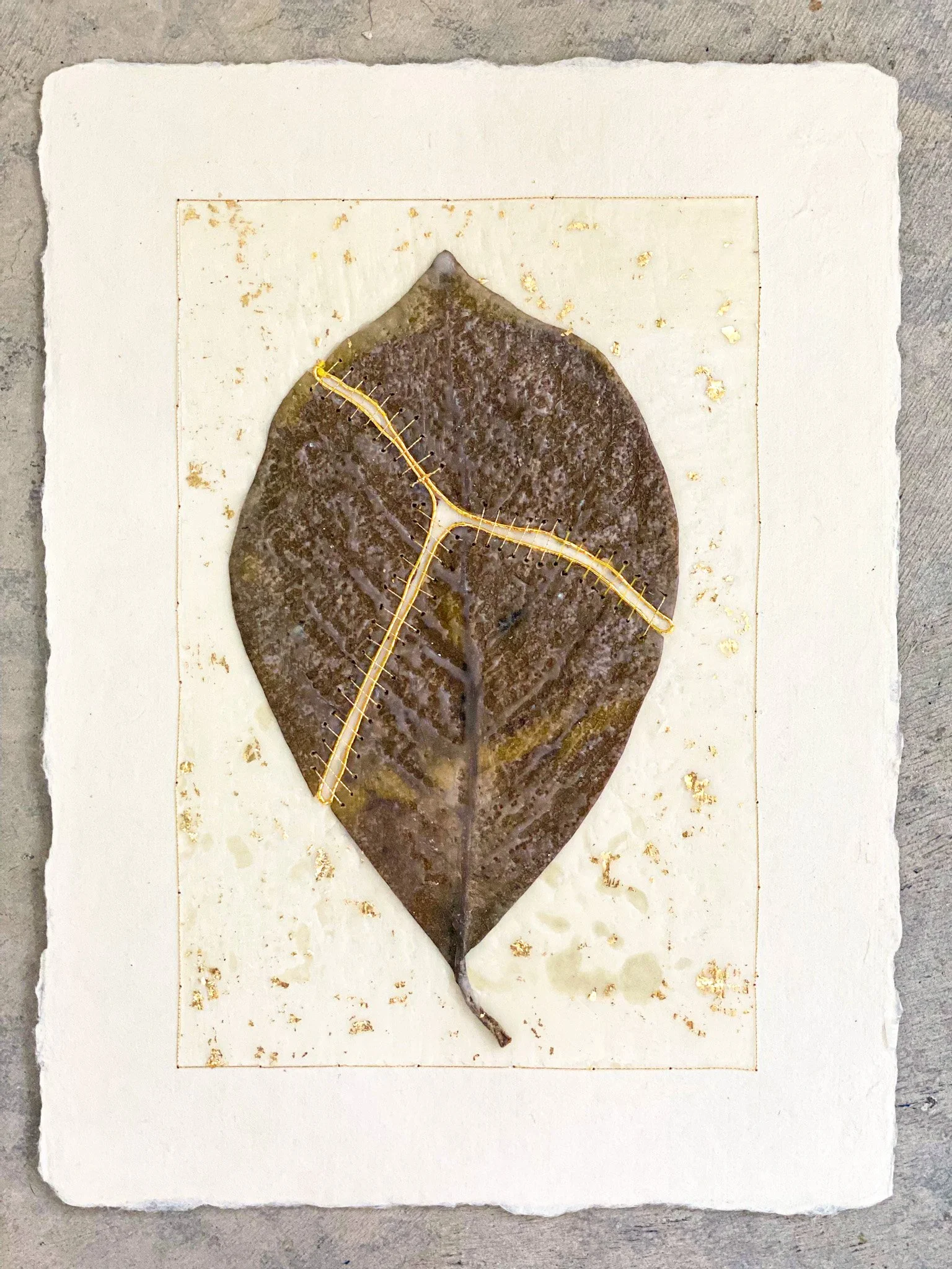  Kintsugi Magnolia Leaf on Paper 
Japanese paper, Magnolia leaf, beeswax, metallic thread, gold leaf
