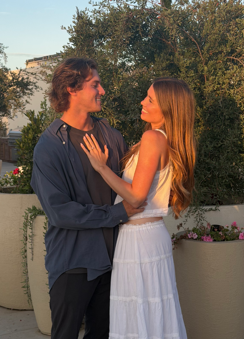 Megan, founder of Saltrock Studios, and her fiancé smiling at each other.