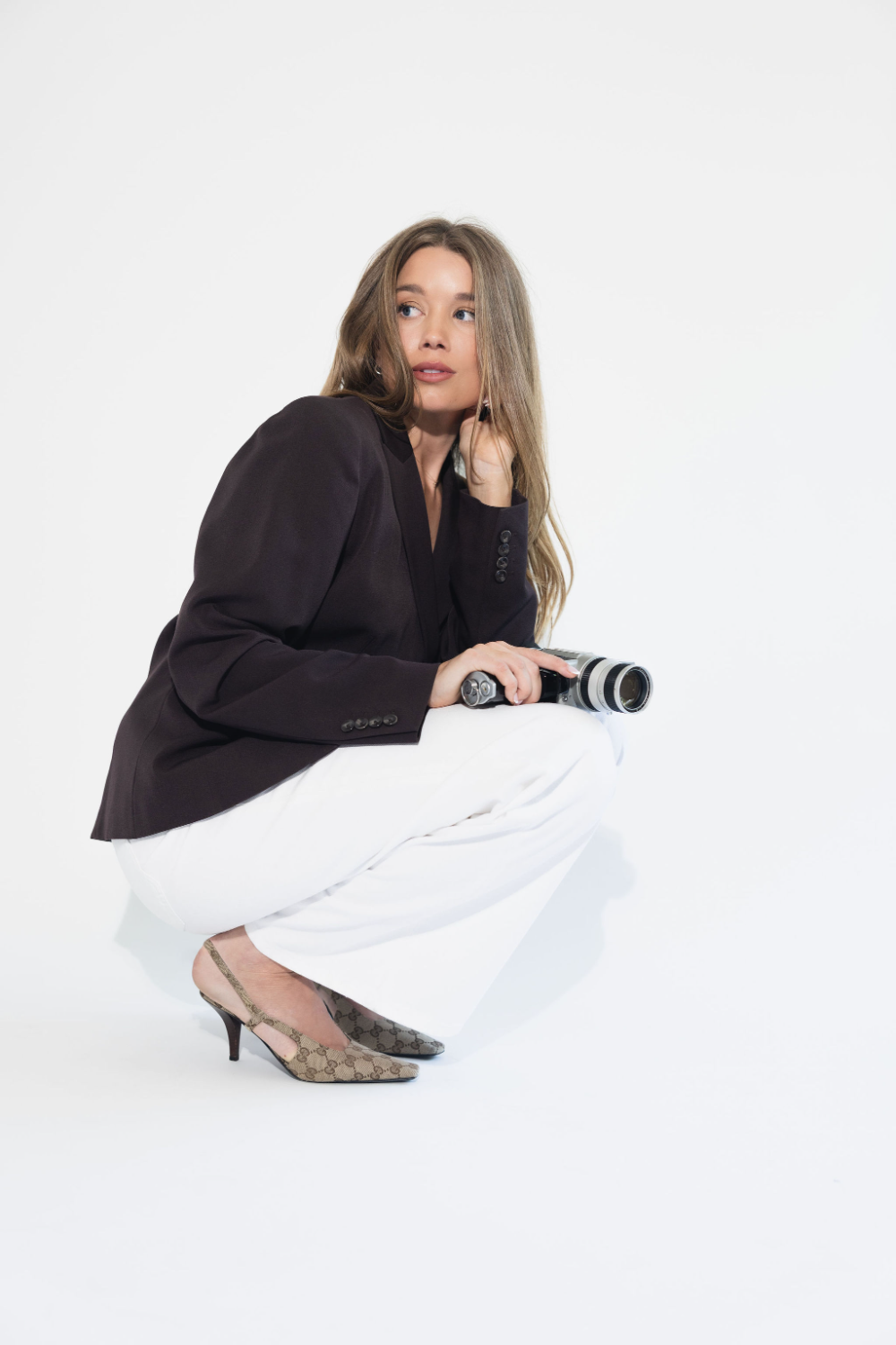 Wedding videographer Megan of Saltrock Studios holding a Super 8 film camera in Los Angeles
