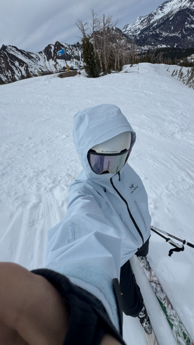 Selfie of Megan, founder of Saltrock Studios, in a light blue ski outfit on a snowy mountain