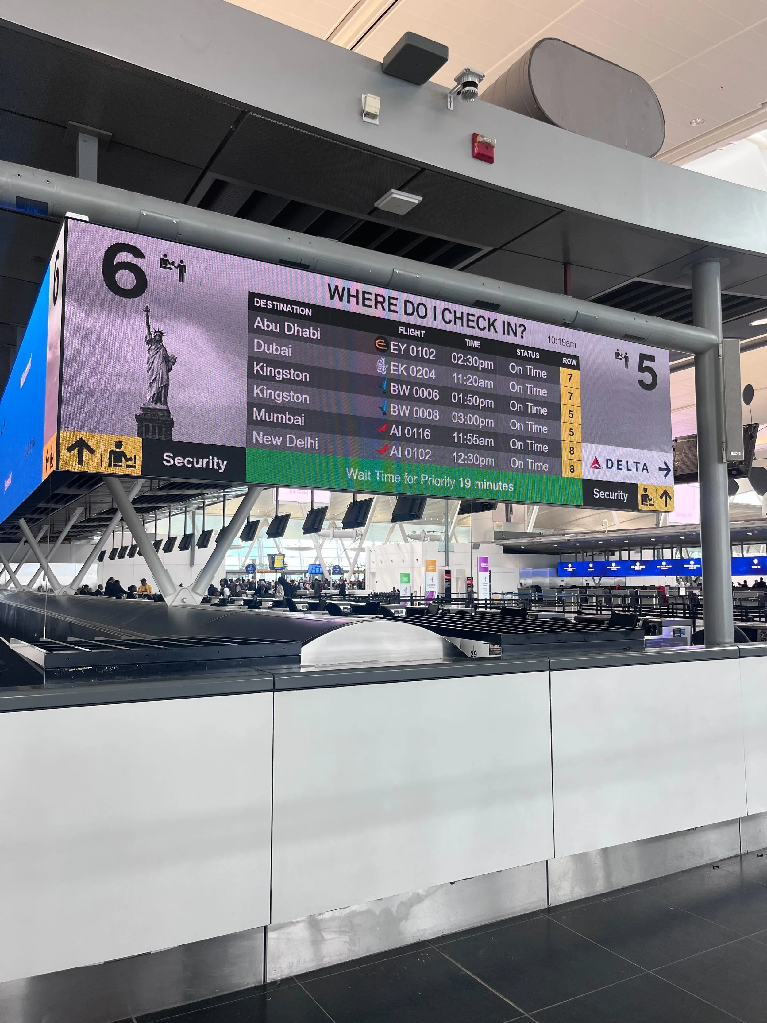 Digital flight information display at an airport showing arrivals and departures for various flights.