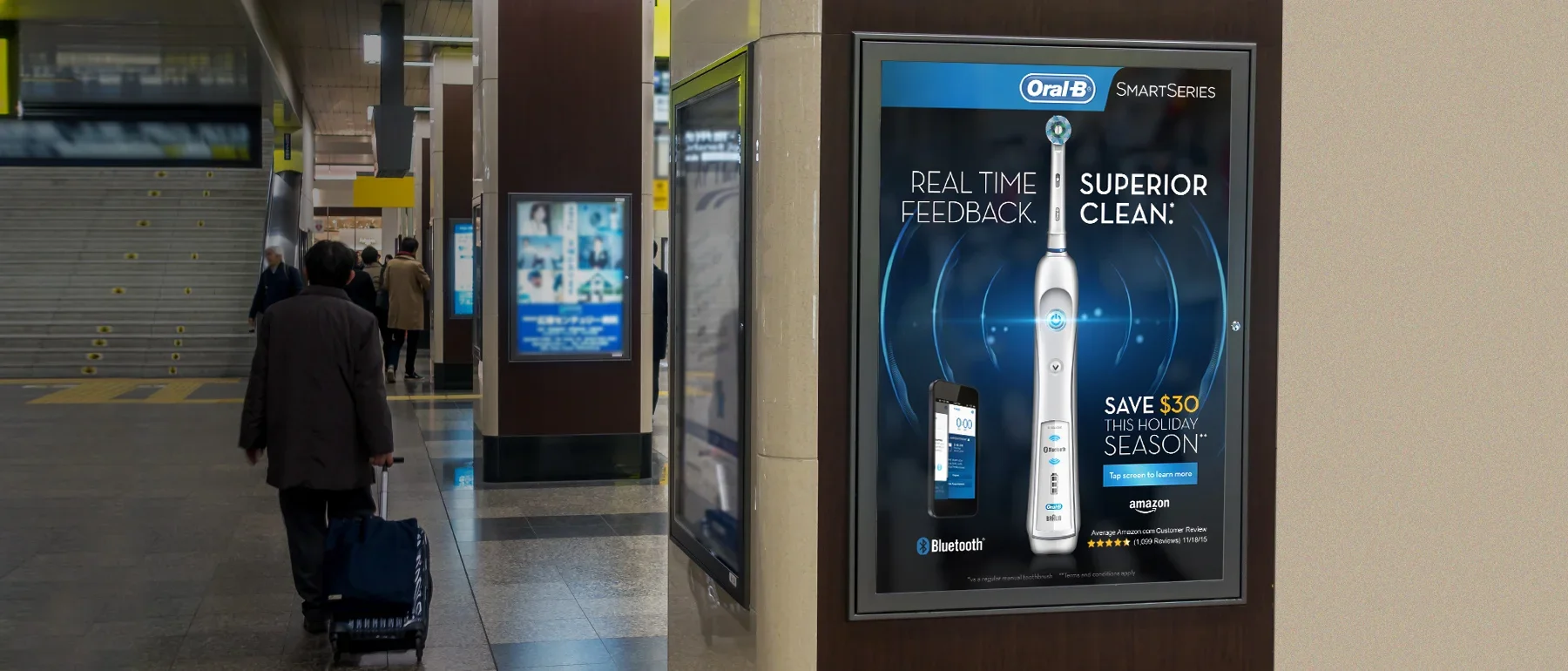 Advertisement for a Sonicare toothbrush featuring Bluetooth and real-time feedback at a train or airport station.