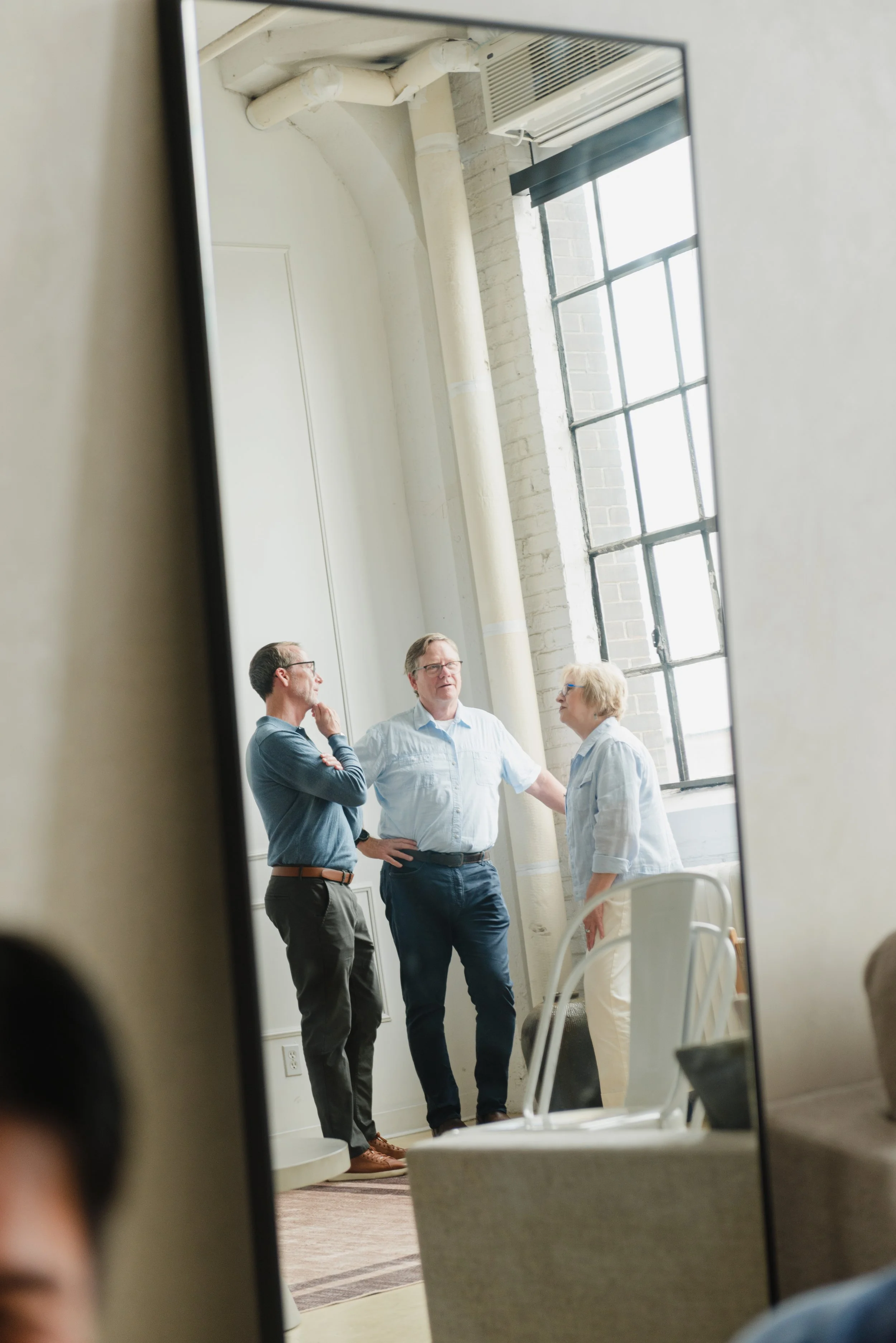 A group of people attending Wendy Shami's workshop, seen through a mirror.