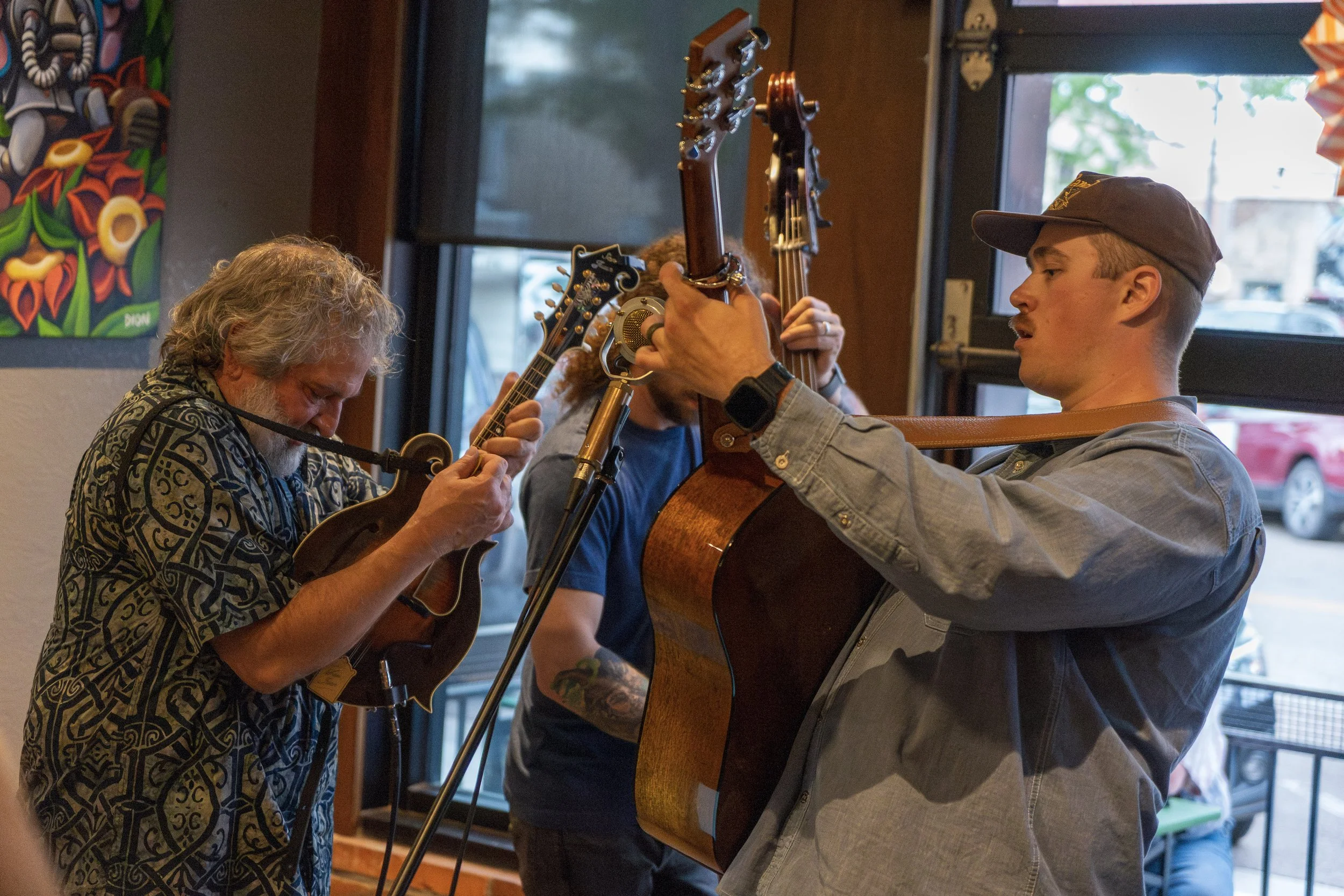 Group of people playing guitars together indoors.
