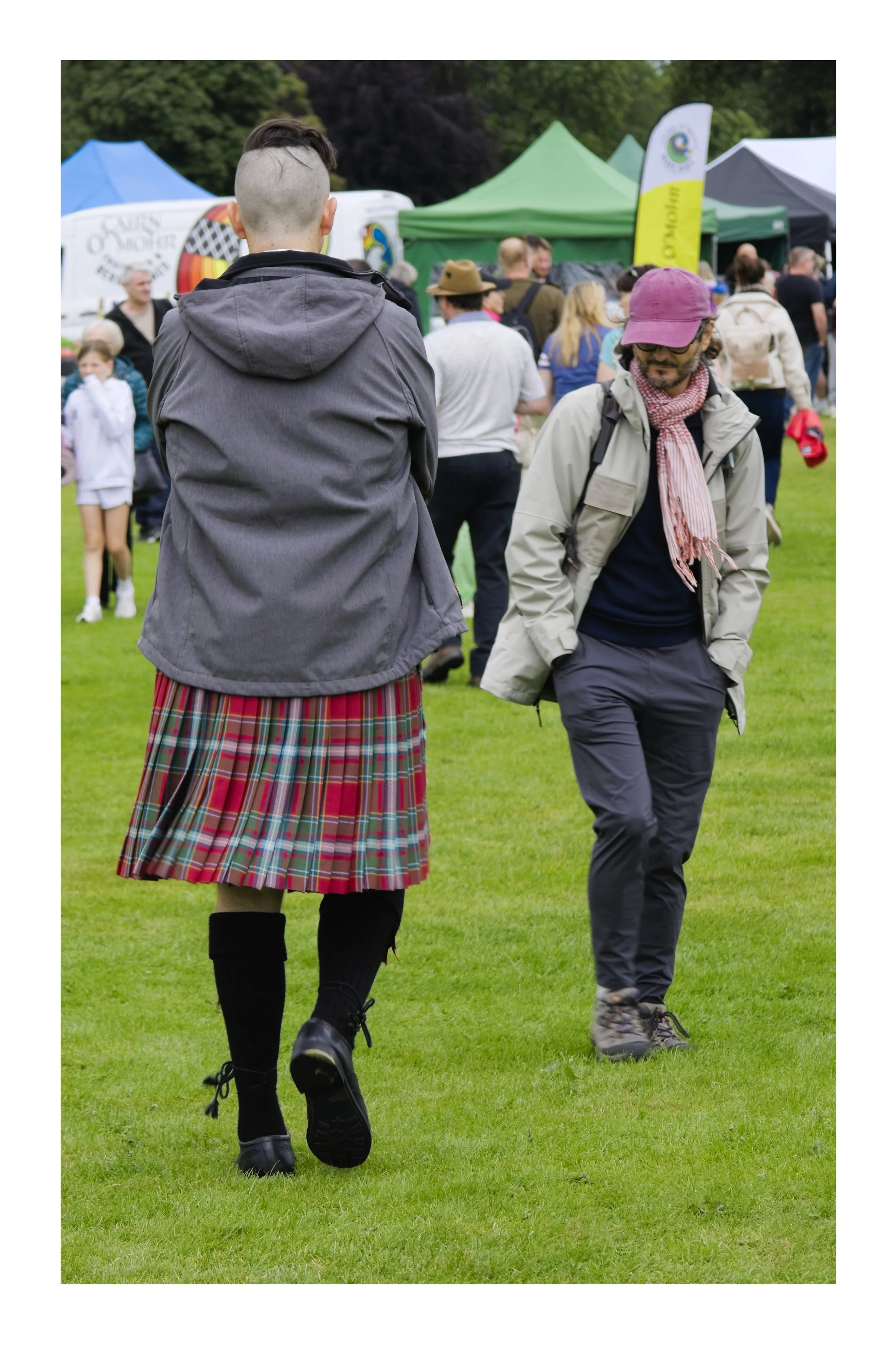 A man walking away in a kilt