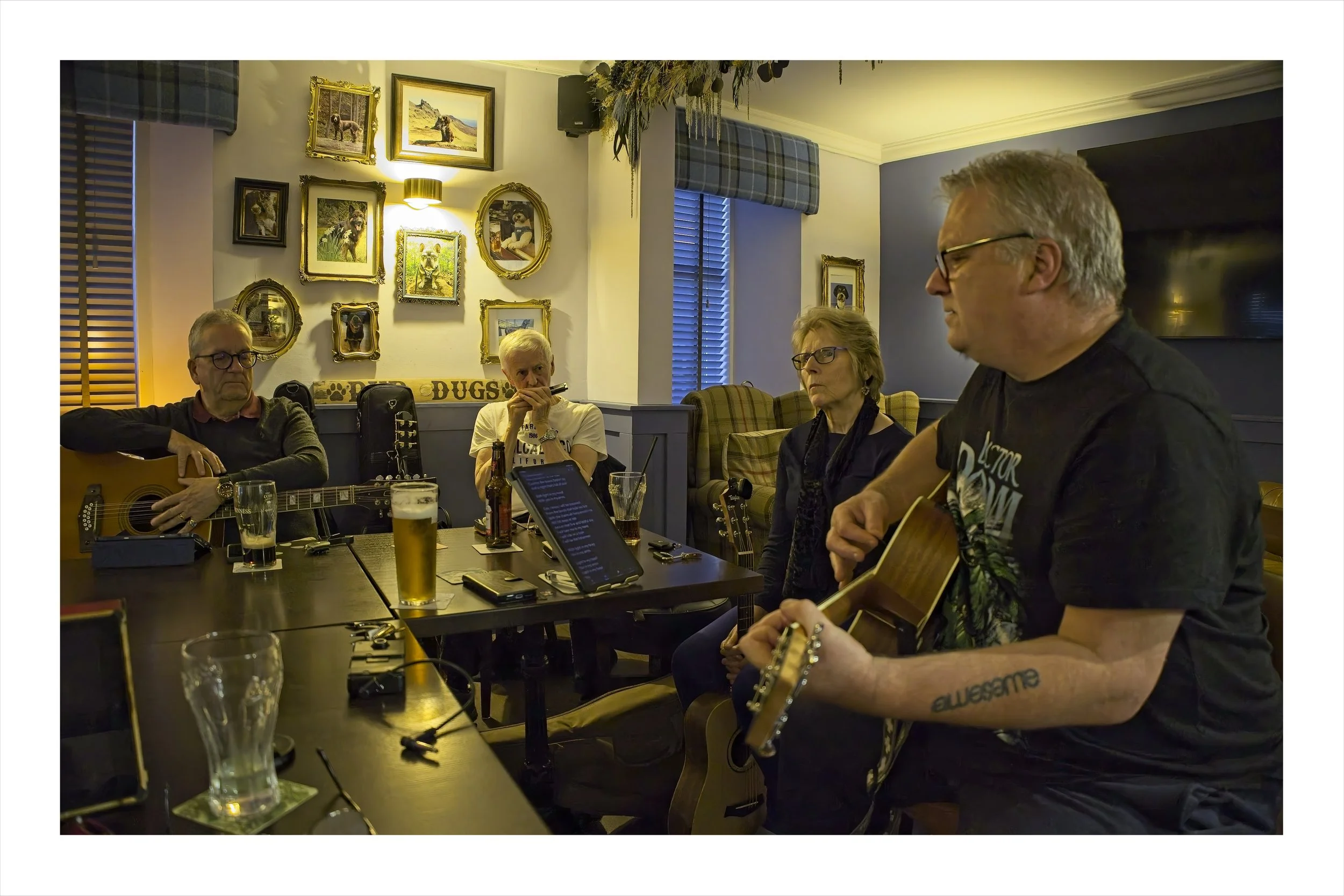 A group of people singing in a pub