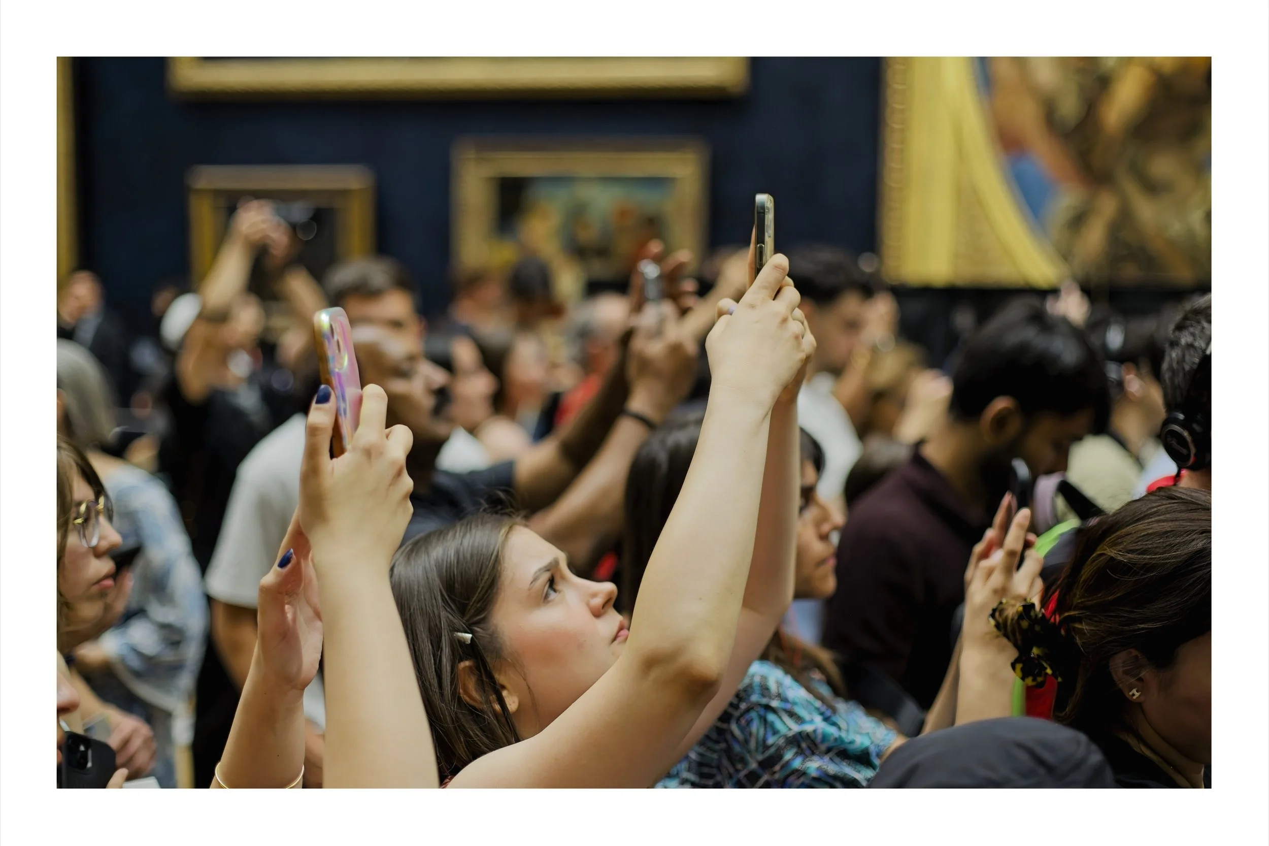 People taking pictures of the Mona Lisa in the Louvre, Paris