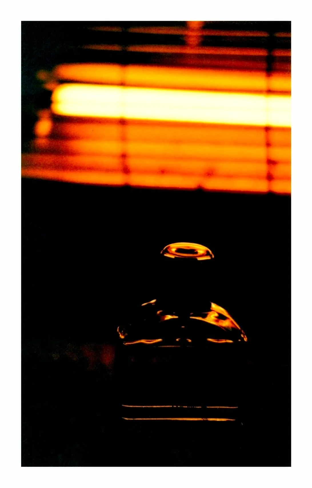An aftershave bottle in front of an electric fire