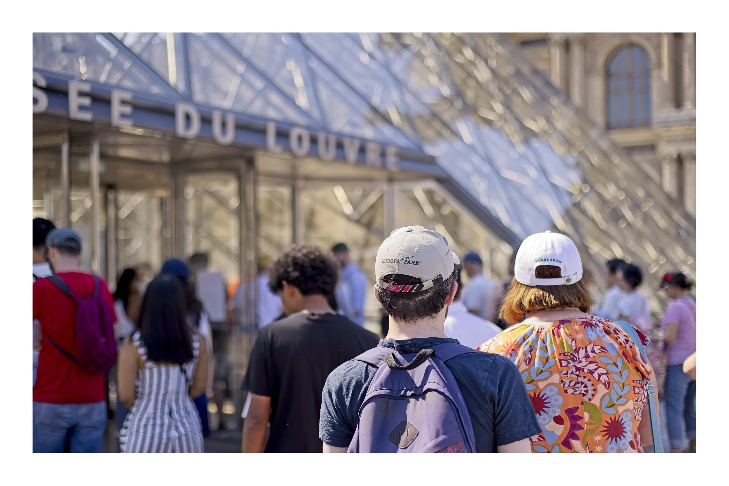 People walking in to the Louvre Gallery in Paris