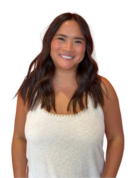 A woman with shoulder-length brown hair smiling, wearing a white sleeveless top, standing against a dark background.