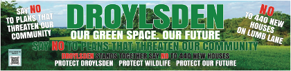 A protest banner with messages defending Droydsen's green space and opposing plans for new houses and roads, emphasizing preserving community and wildlife.