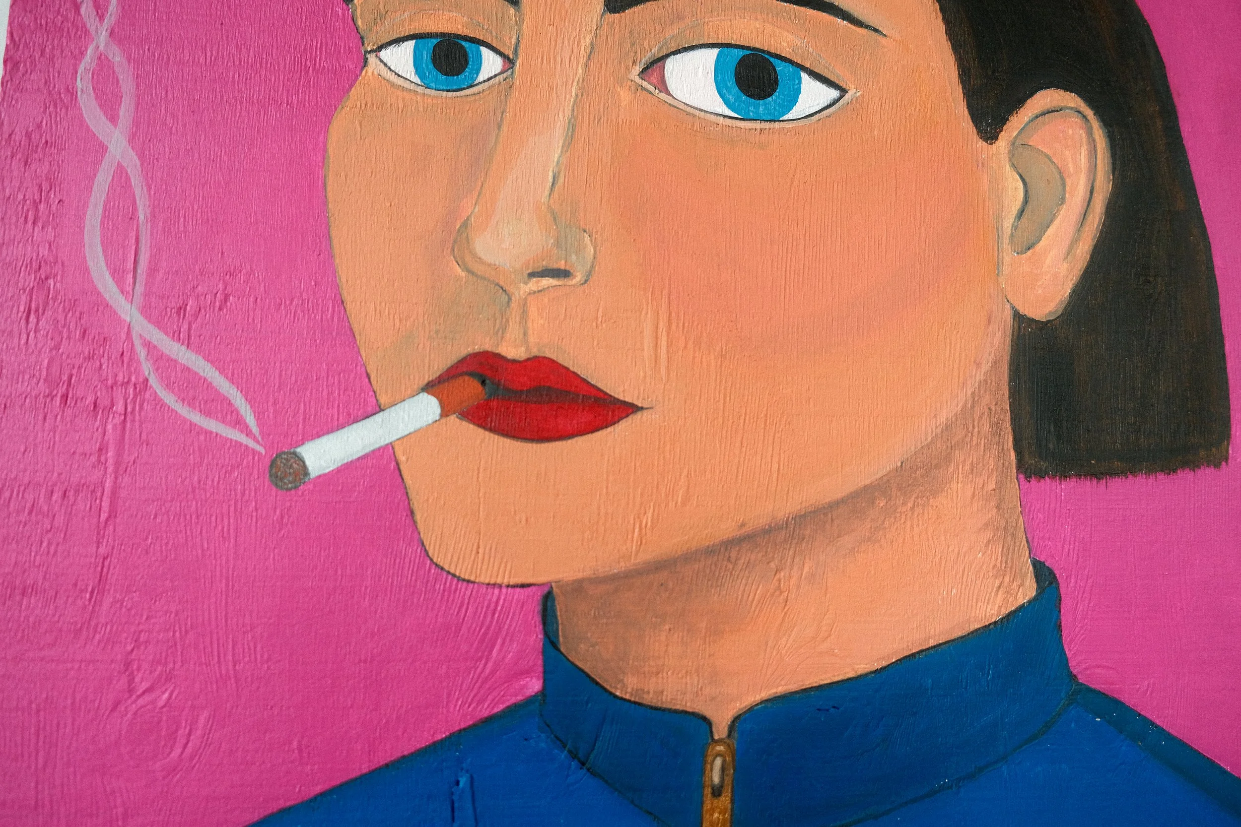 Detail of the painting I used to smoke. A close-up of the big blue eyes, dark hair, bold red lips, smoking a cigarette with pink background.
