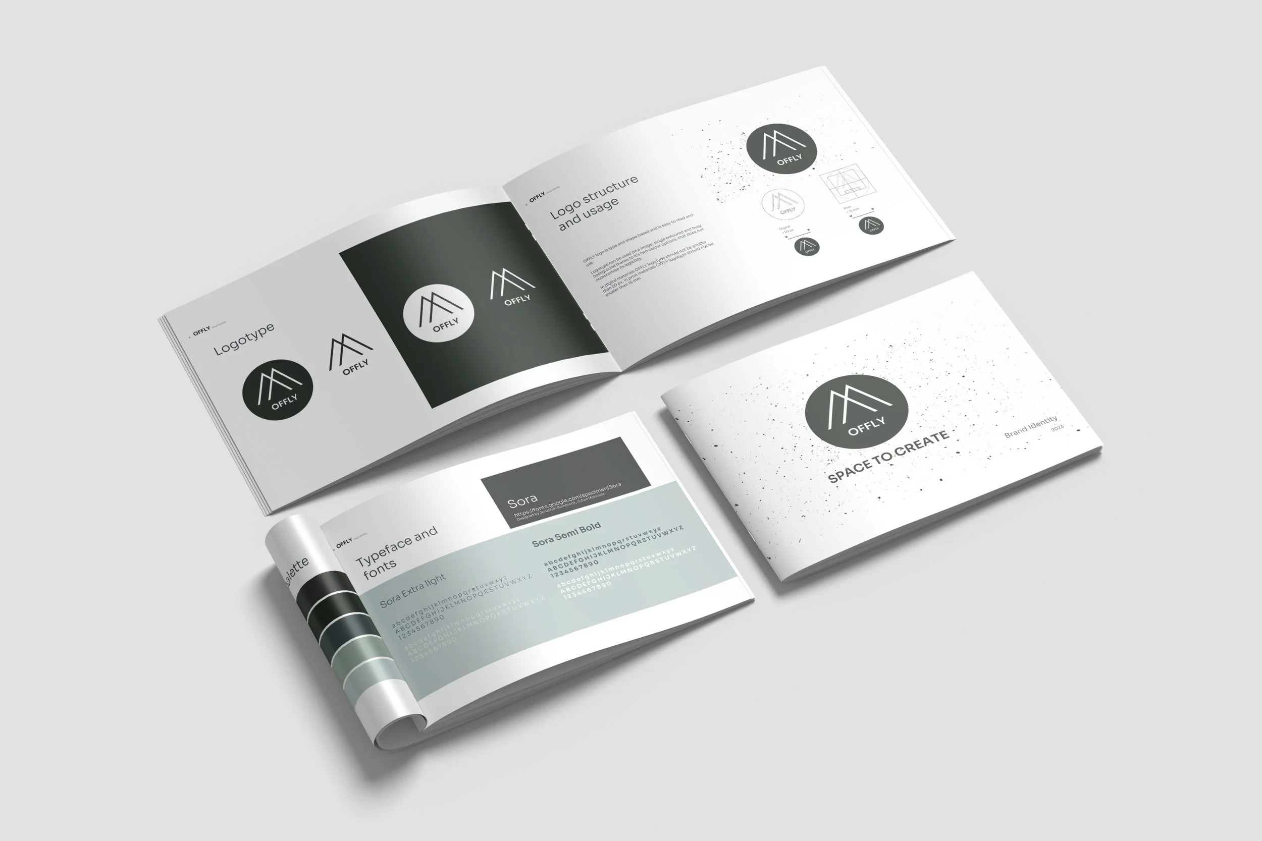 Open brand book featuring logo design concepts, typography, and usage guidelines on a gray background.