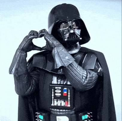 Darth Vader from Star Wars making a heart shape with his hands.
